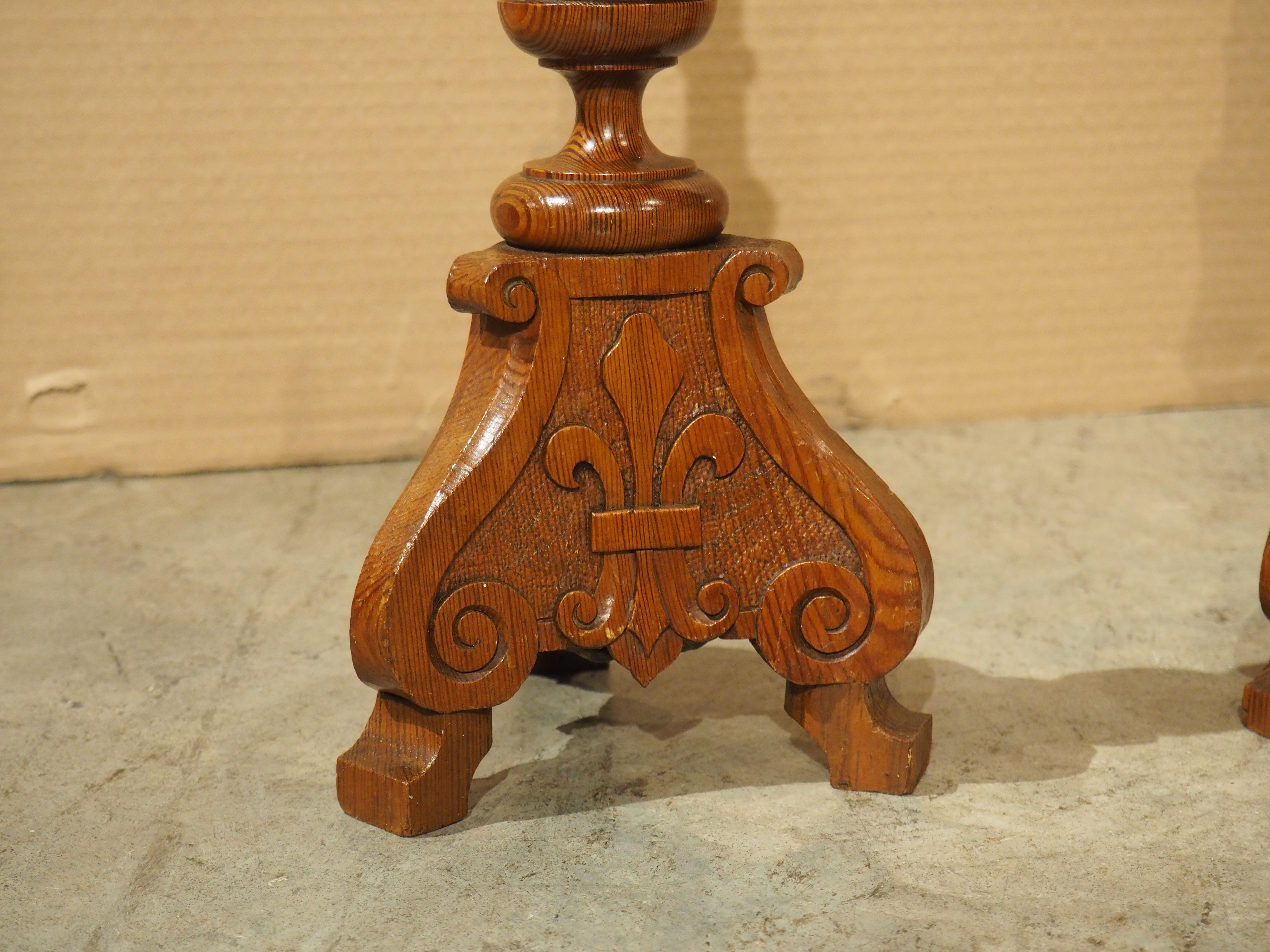 Hand-Carved Pair of Early 1900's French Pine Candlesticks with Fleur De Lys Relief Carvings For Sale