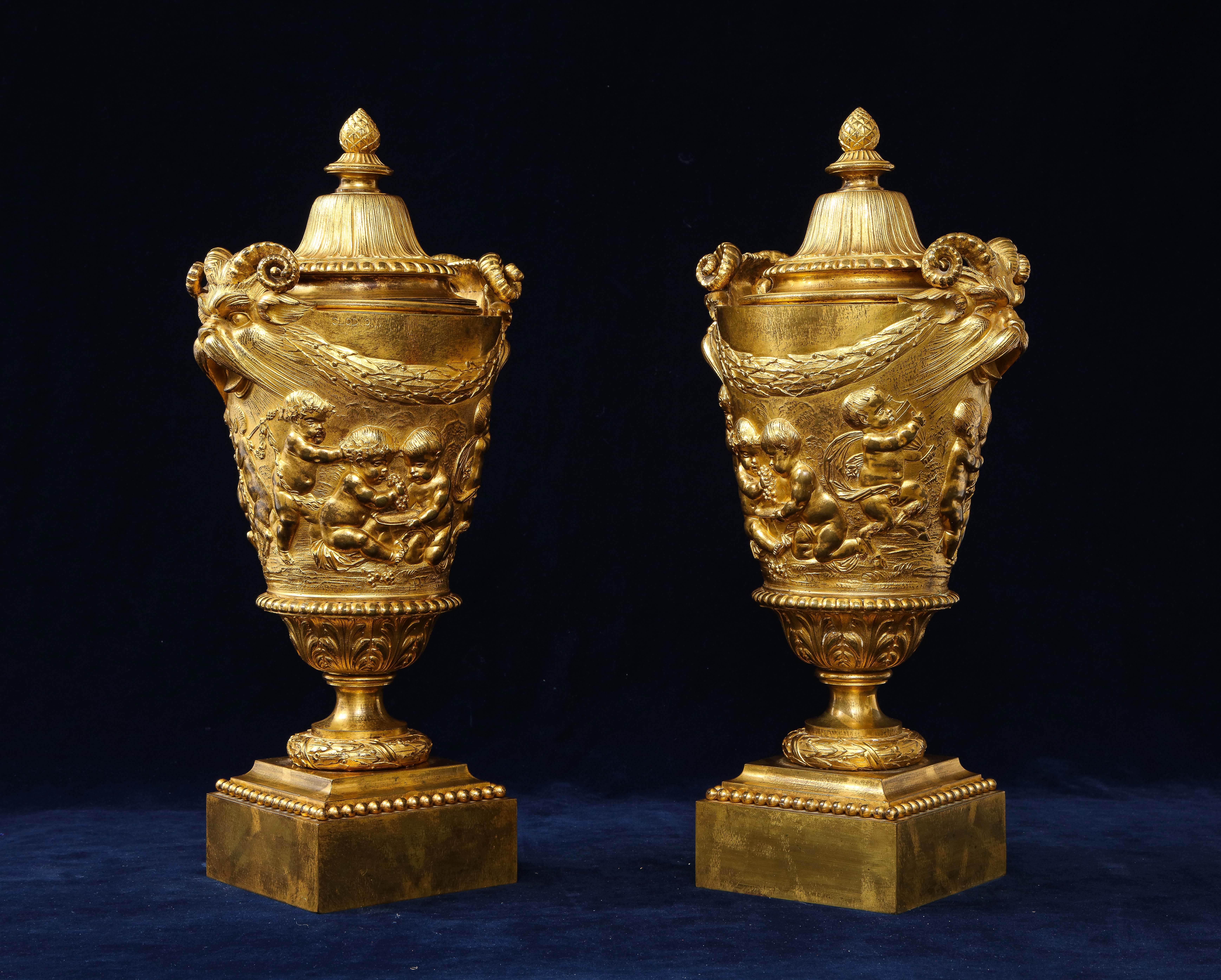 An Extraordinary Pair of Early 1800's French Ormolu Covered Vases, in the style of CLAUDE MICHEL, Signed Clodion.  After the original terracotta vase by Clodion in 1763.  These ormolu vases represent an extraordinary confluence of painting and
