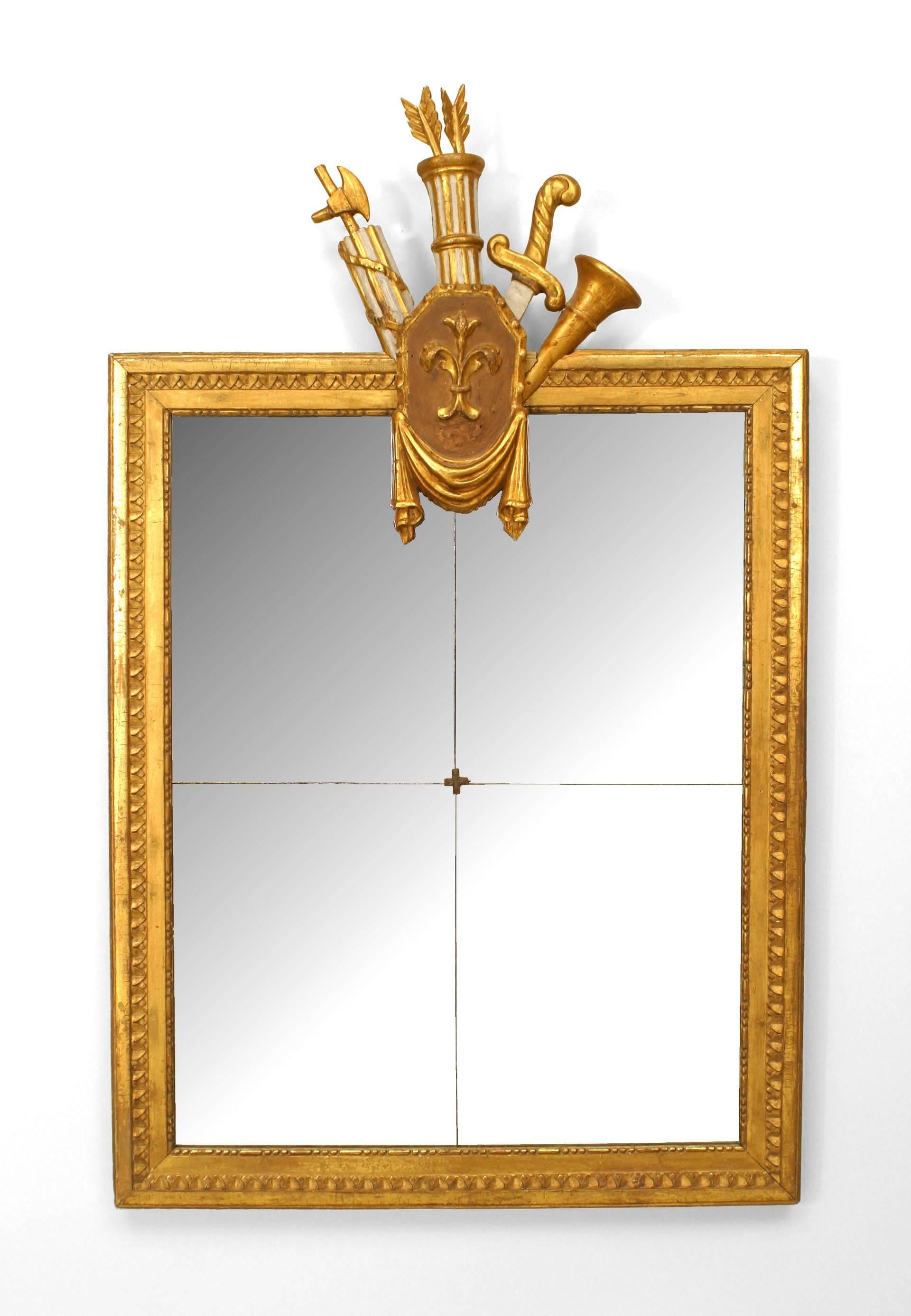 Pair of Italian Neoclassic (18/19th Century) gilt framed wall mirrors with four glass panels and a white painted and gilt trophy carved pediment with a fleur-de-lis design. (PRICED AS Pair)
