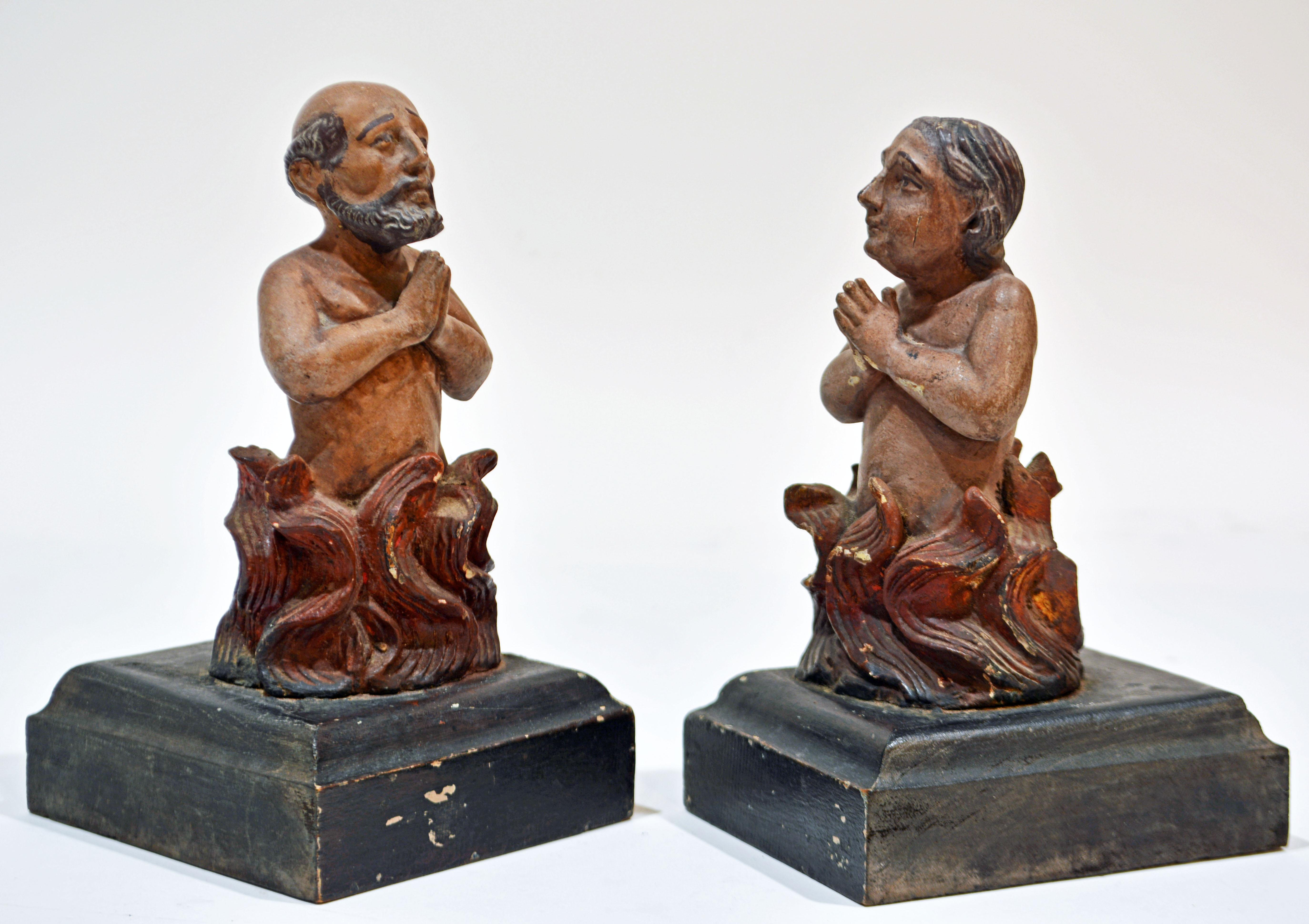 Dating to the early 19th century these small 'Anima Sola' ('Lonely Souls') carved and polychrome painted figures depict a man and a woman engulfed in the flames of Purgatory. Their faces are beautifully individualized and the figures express both