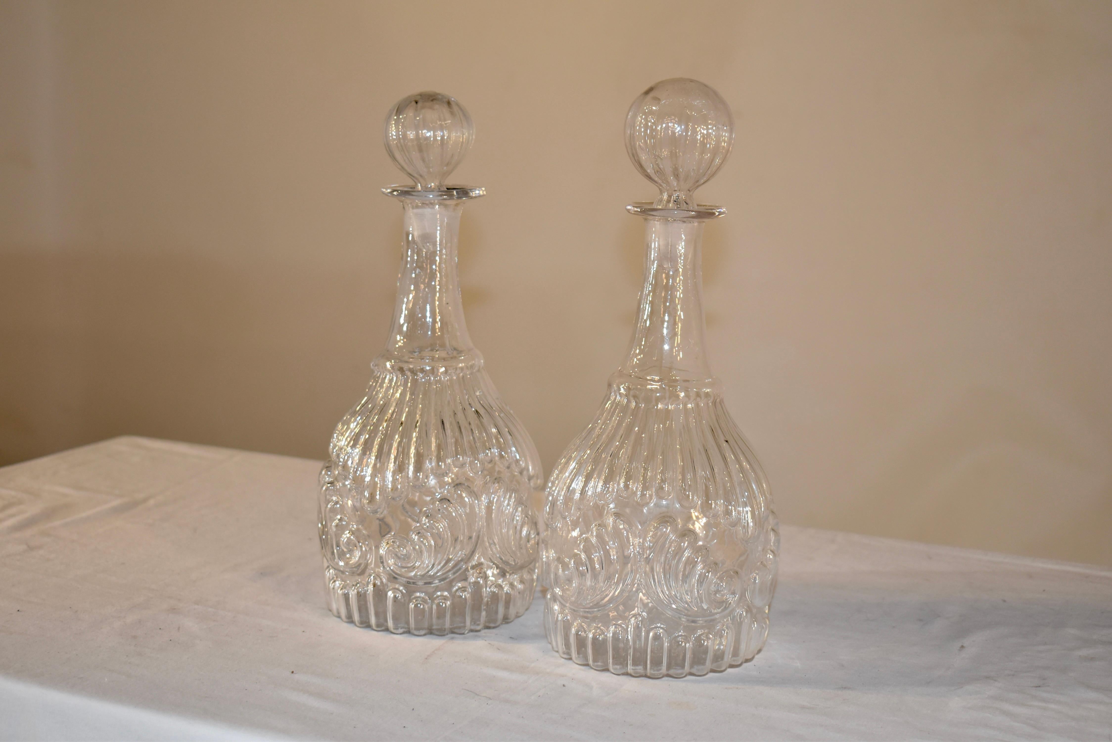 Pair of early 19th century hand mold blown glass decanters.  These are a gorgeous pair of molded glass decanters, probably from New England.  The glass trade was very popular in the 19th century of our budding country, as the people wanted more