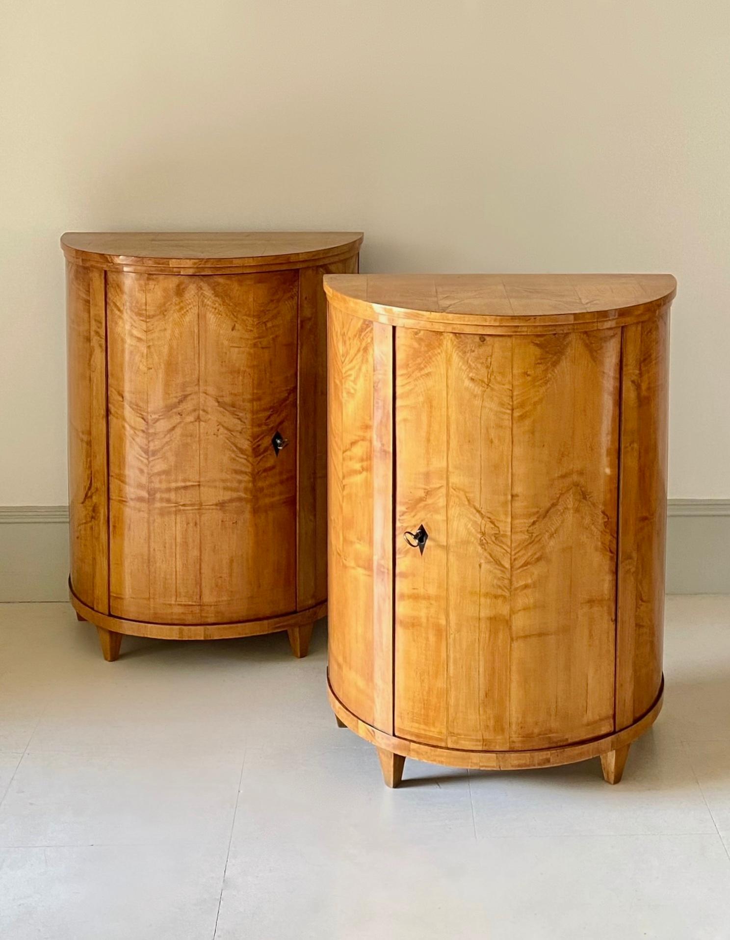 Carved Pair of early 19th Century Biedermeier Maple Demi-lune Side Cabinets.