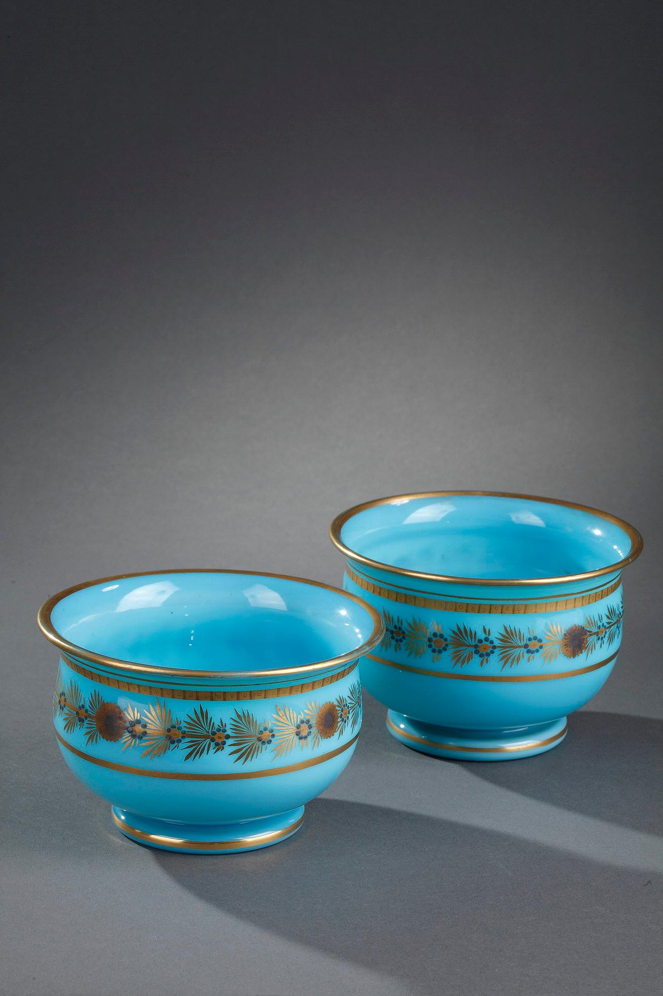 A pair of blue opaline bowls decorated with a frieze of daisies and forget-me painted in dark blue, ocher and gold, and golden nets. The simplicity and subtlety of this pattern is representative of the production of Jean-Baptiste Desvignes, the most