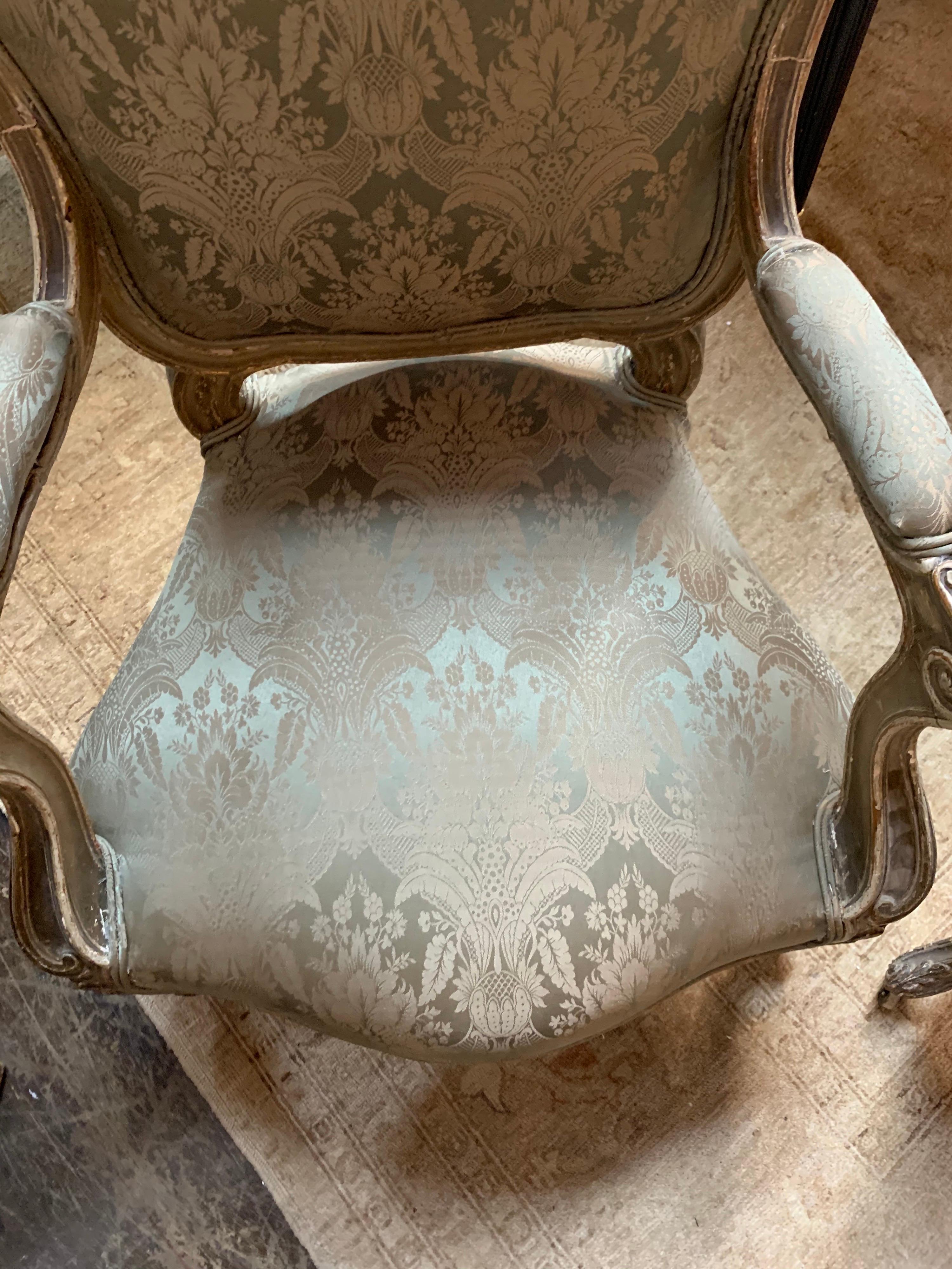 Exquisite pair of 19th century carved and painted Italian armchairs. Very fine carvings along with beautiful sage green colored fabric. A great pair for a lovely home!