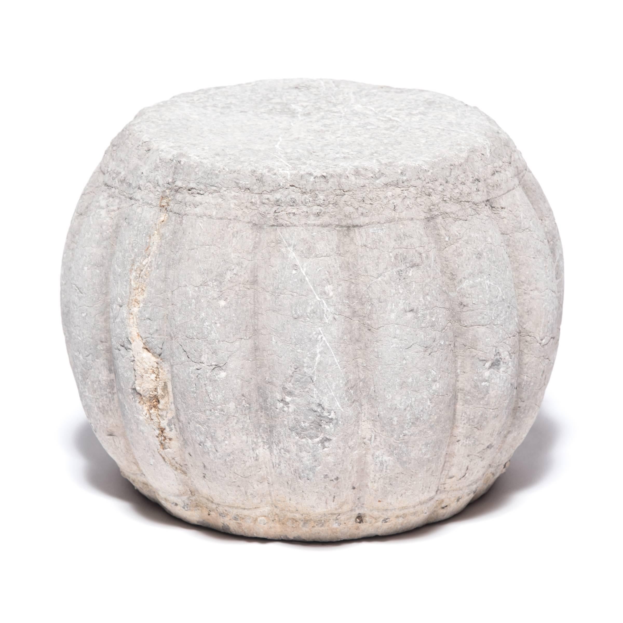 Hand-carved from limestone, these drum-shaped pedestals swell to a ribbed squash shape, an ancient symbol of fertility. The artist used a hobnail-like texture on either end of each pedestal to suggest the rivets that fasten skin stretched over a