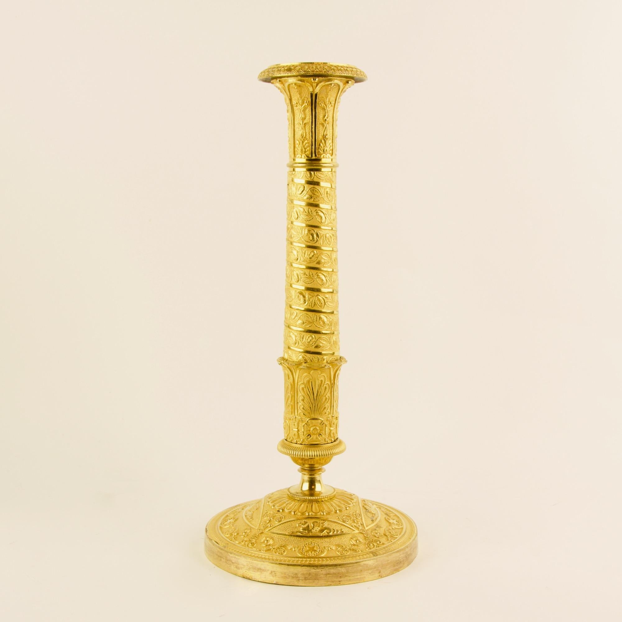 Pair of early 19th Century Empire Trajan's column ormolu candlesticks in the manner of P.-P. Thomire (1751-1843):

Pair of large Empire ormolu candlesticks, the stem ressembling the Trajan's column or the column of the place Vendôme in Paris