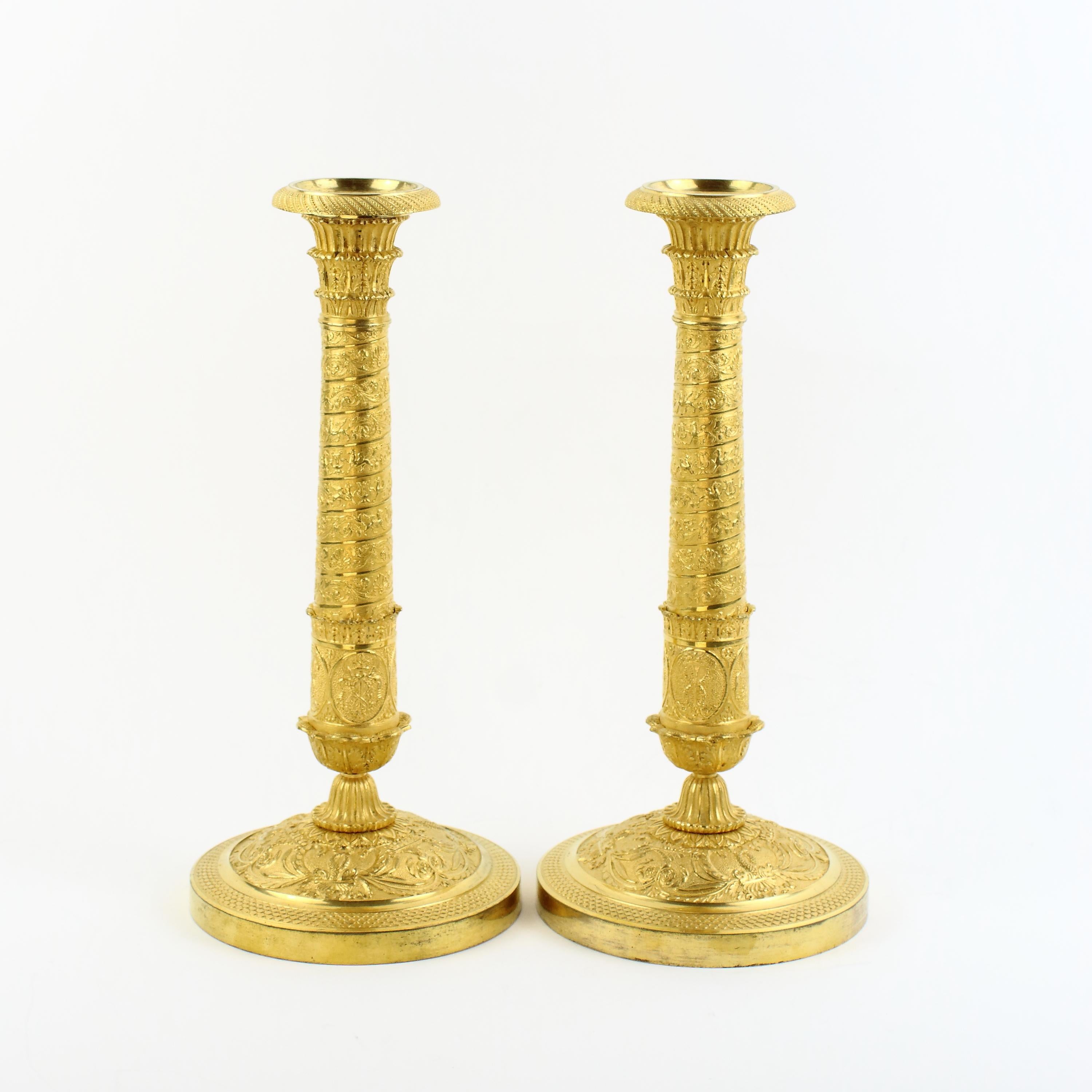 Pair of early 19th century Empire Trajan's column ormolu candlesticks in the manner of P.-P. Thomire (1751-1843):

Pair of large Empire ormolu candlesticks, the stem ressembling the Trajan's column or the column of the place Vendôme in Paris