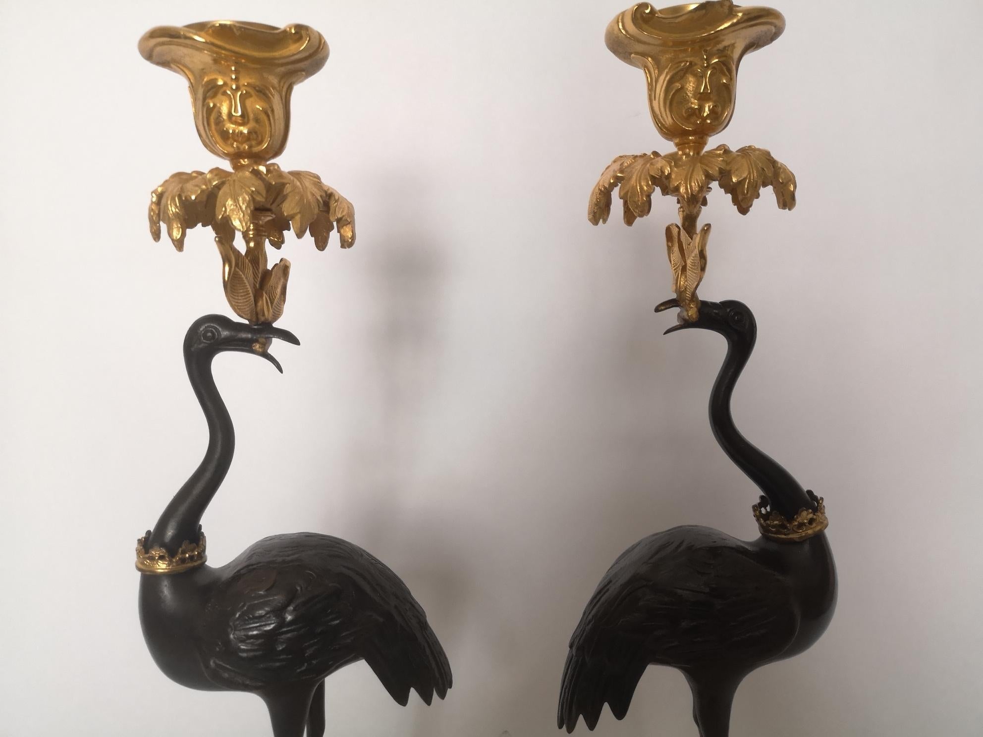 A pair of early 19th century English candlesticks. Modelled as bronze standing storks on rocky gilt bases, the cranes have hold gilt candleholders in their mouths and a gilt crown around their necks.
Signed 'Abbott'
English, circa 1840.