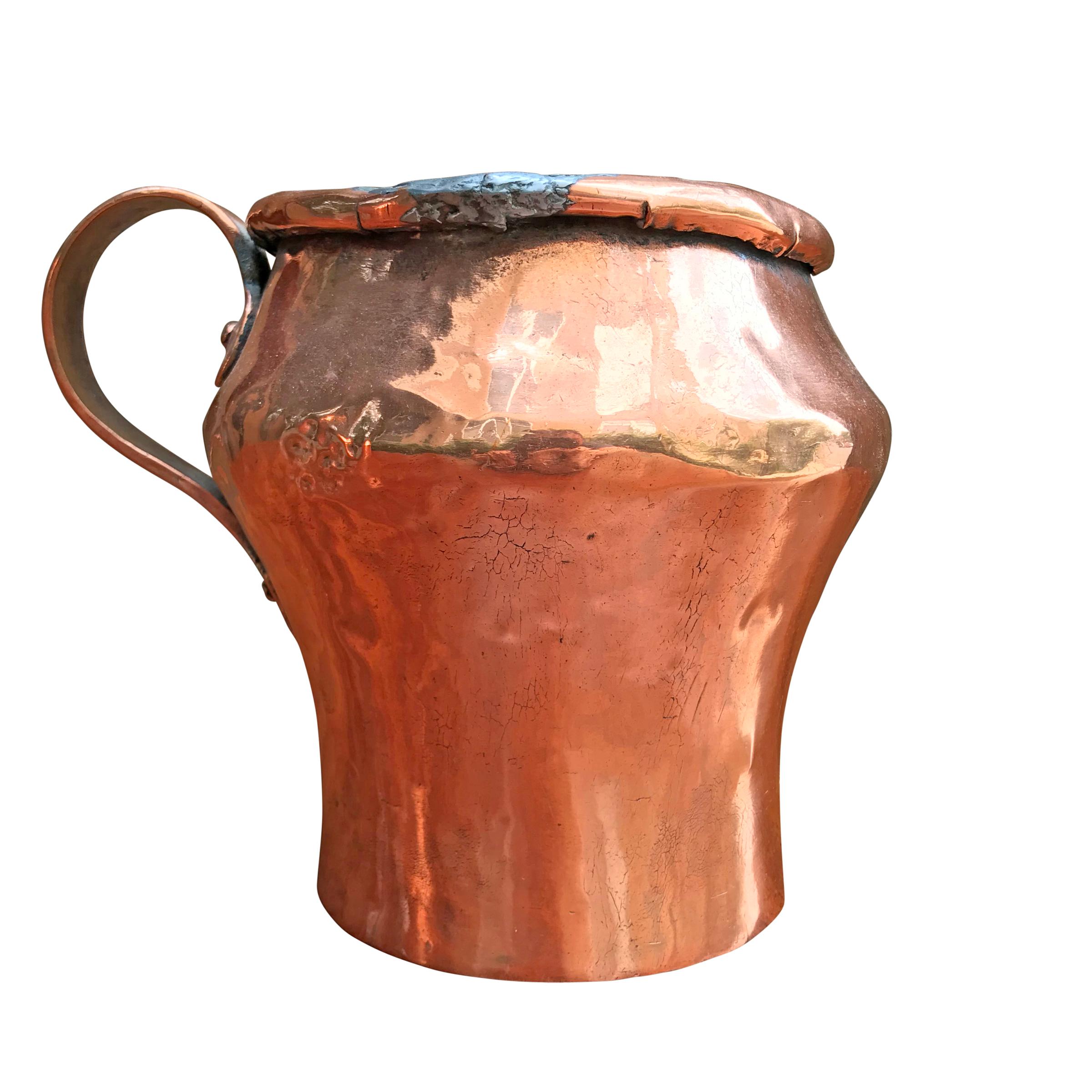 Pair of early 19th century English copper pitchers with riveted copper handles, and old repairs. One with a banded bottom. These are water tight, and would make the best vases with fresh flowers, and are wide enough to chill a wine