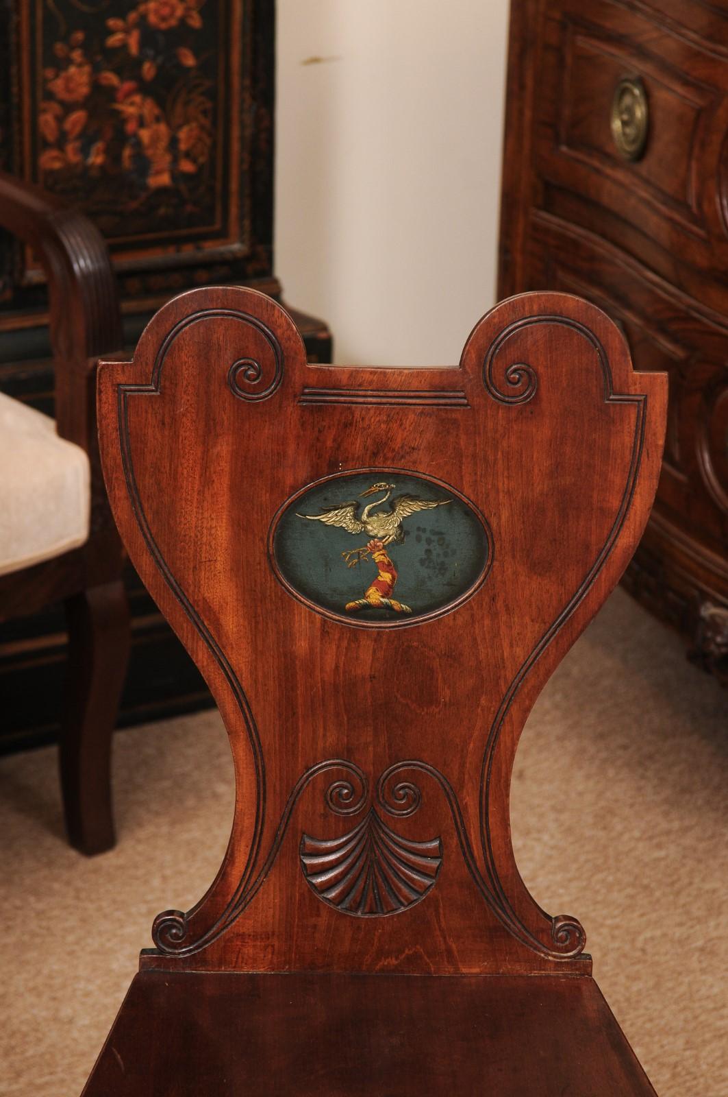 Pair of Early 19th Century English Mahogany Hall Chairs with Black Painted Crest For Sale 8