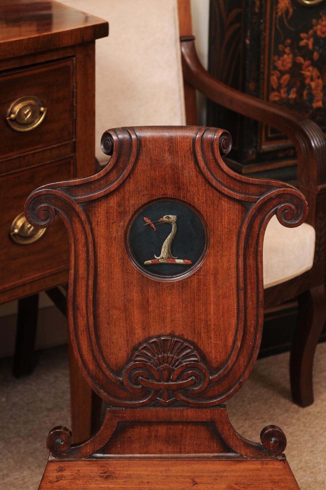 Pair of Early 19th Century English Mahogany Hall Chairs with Black Painted Crest For Sale 9
