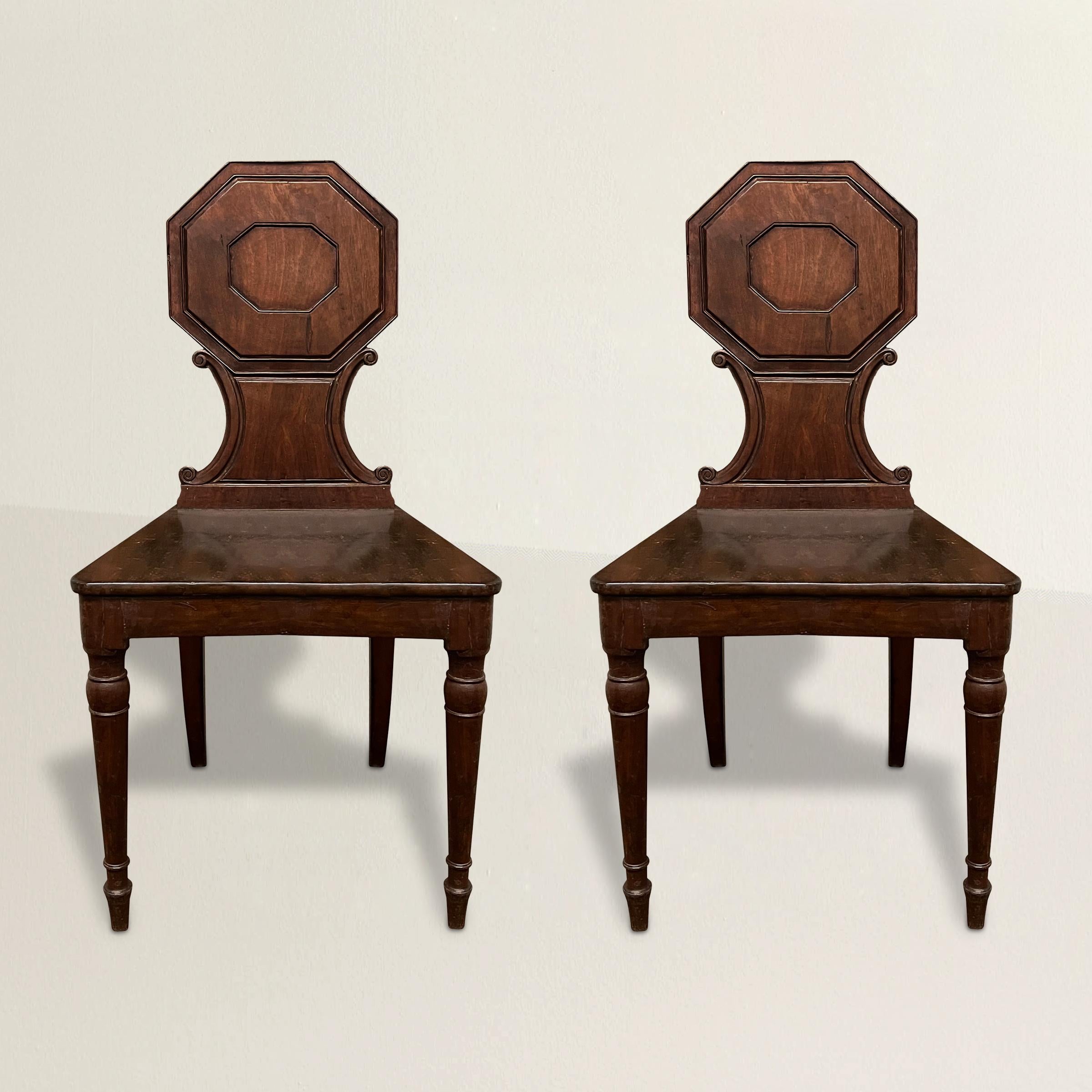 Indulge in the refined elegance of these early 19th century English Regency Period mahogany hall chairs, a true testament to the splendor of the era. Crafted with meticulous attention to detail, these chairs exhibit the characteristic traits of