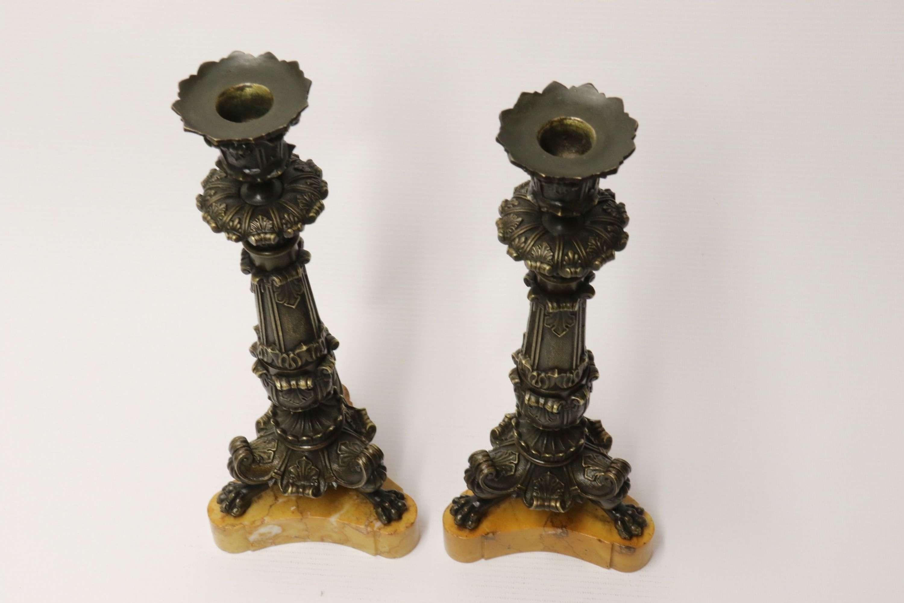 A superb pair of early 19th C French empire bronze candlesticks.

This very fine pair of early 19th century French candlesticks are ornately modelled in the Empire style. They stand raised on shaped and polished sienna marble plinths which are