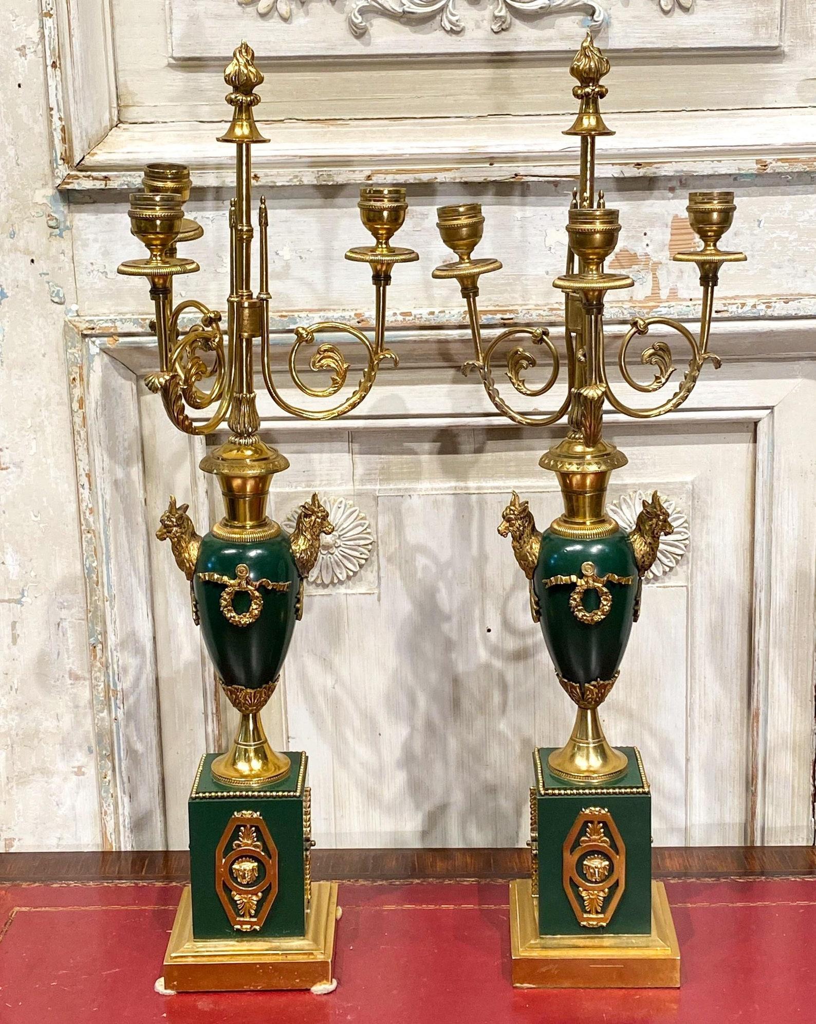A stunning pair of period Empire gilt patinated brass and bronze candelabras.

Born in France in the early 19th century, fine quality and detailing, elaborately decorated, unique design, likely Parisian, with strong classical era influence.