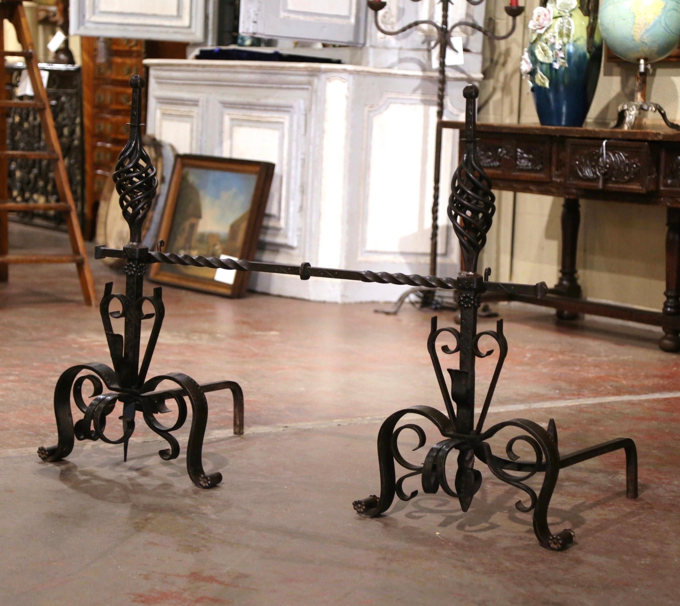 Decorate a fireplace with this three-piece set antique wrought iron andirons. Crafted in France, circa 1860, the fireplace tools were expertly forged and feature a design which includes scrolls on the base and the main stem, and a twisted bar