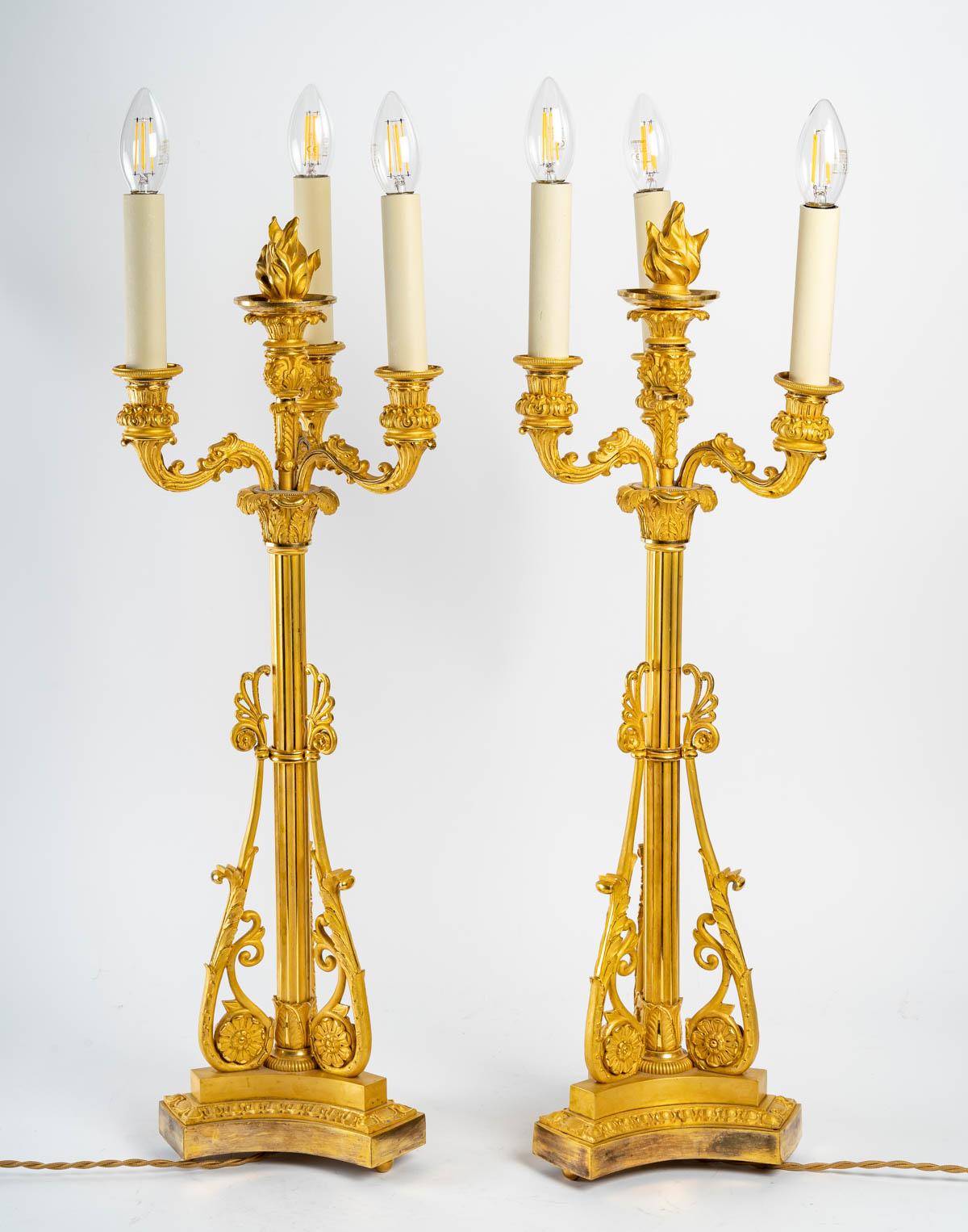 Pair of early 19th century gilt bronze candlesticks, gilded with mercury. 
Measures: H: 69 cm, W: 24 cm, D: 24 cm.
