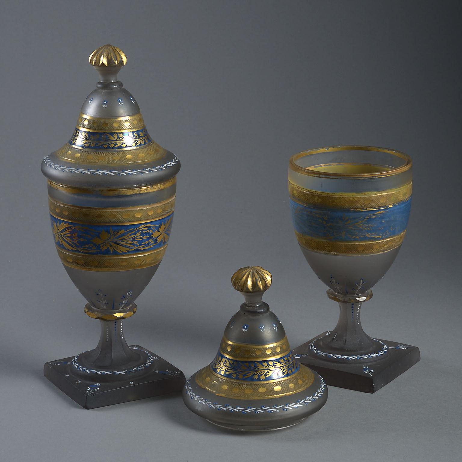 The urn shaped form decorated with bands of engraved and gilt foliage on a frosted and partly blue-painted ground.