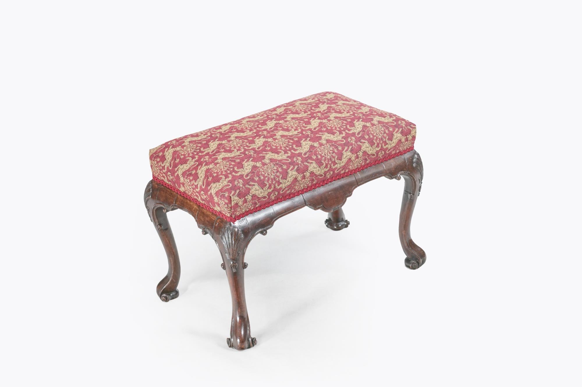 Pair of early 19th Century Irish mahogany stools with shaped legs featuring carved shells and scroll feet.