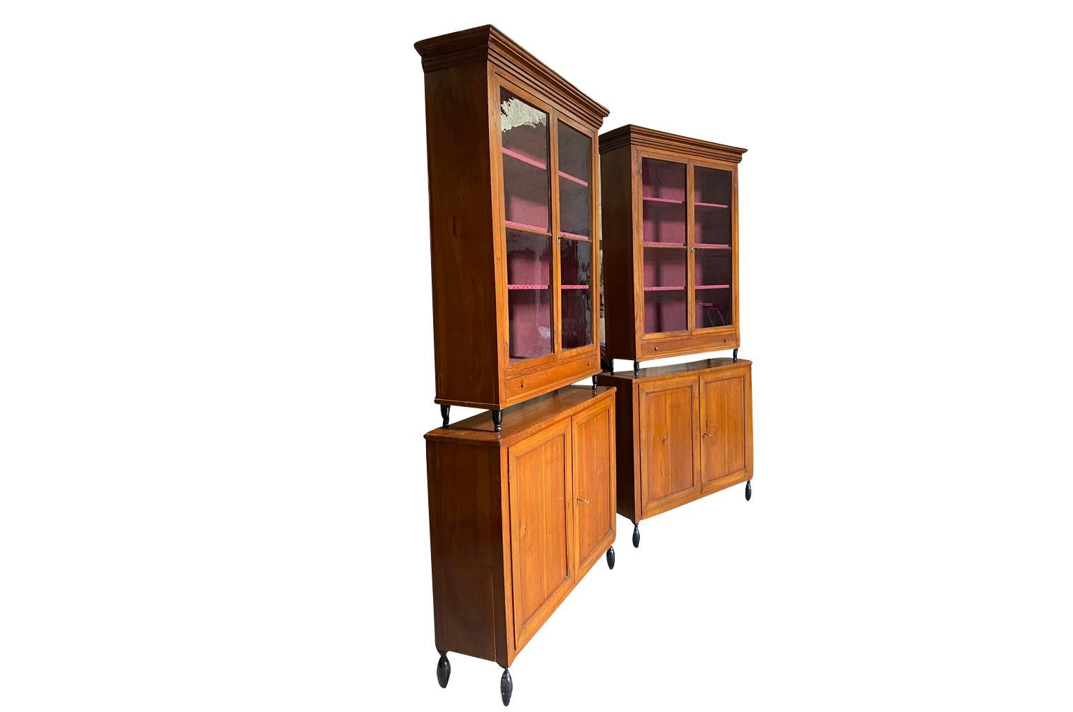 A very elegant pair of early 19th century Deux Corps Bibliotheque - Bookcase from the Veneto region of Italy, Beautifully constructed from stunning walnut. The upper sections retaining their original glass panes, drawers and shelving. The lower