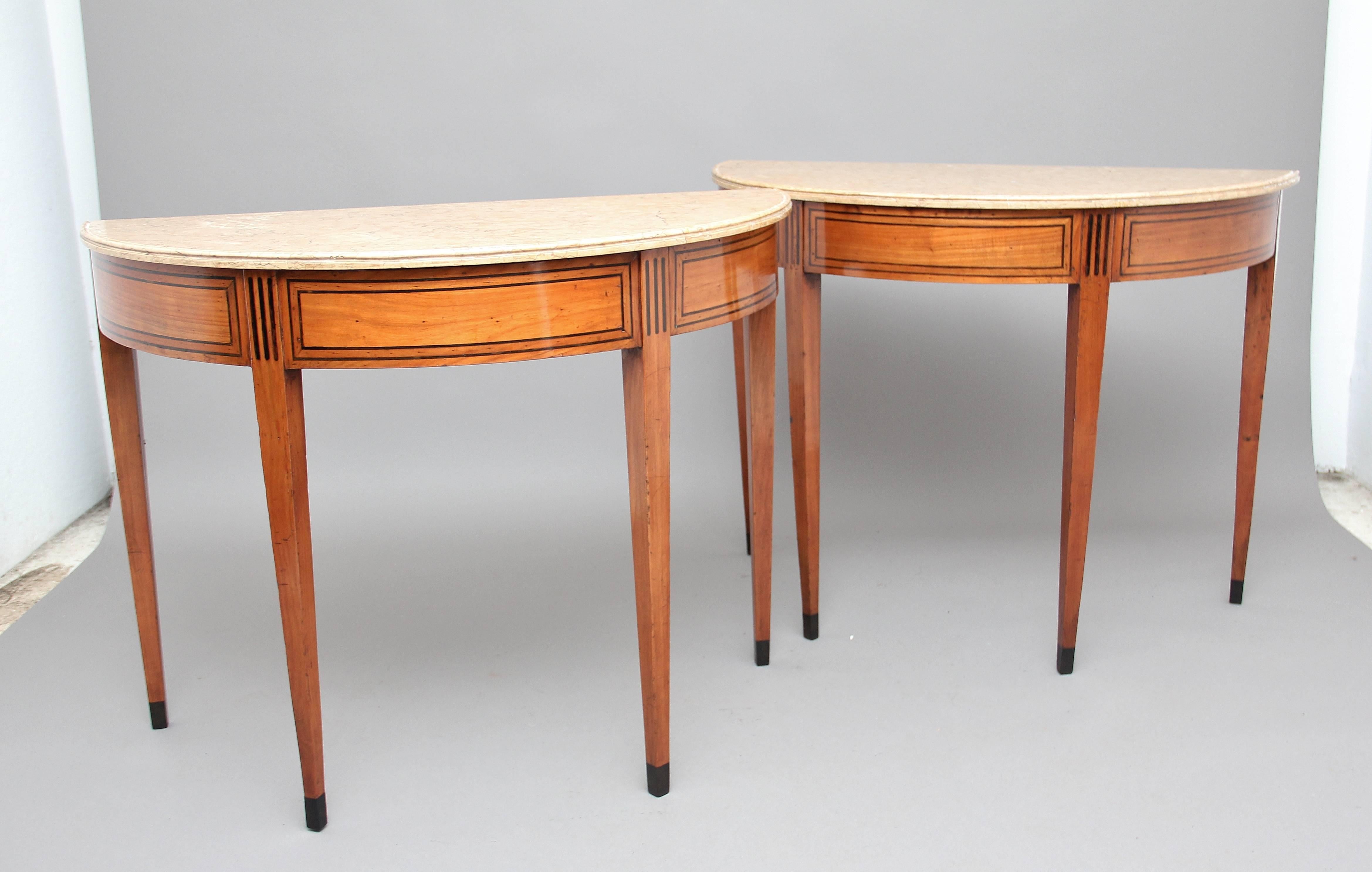 A superb pair of early 19th century Italian fruitwood consul tables inlaid with ebony, the ebony inlay works very well with the lovely warm colour of the fruitwood, having lovely figured and moulded marble tops, standing on square tapered legs. A