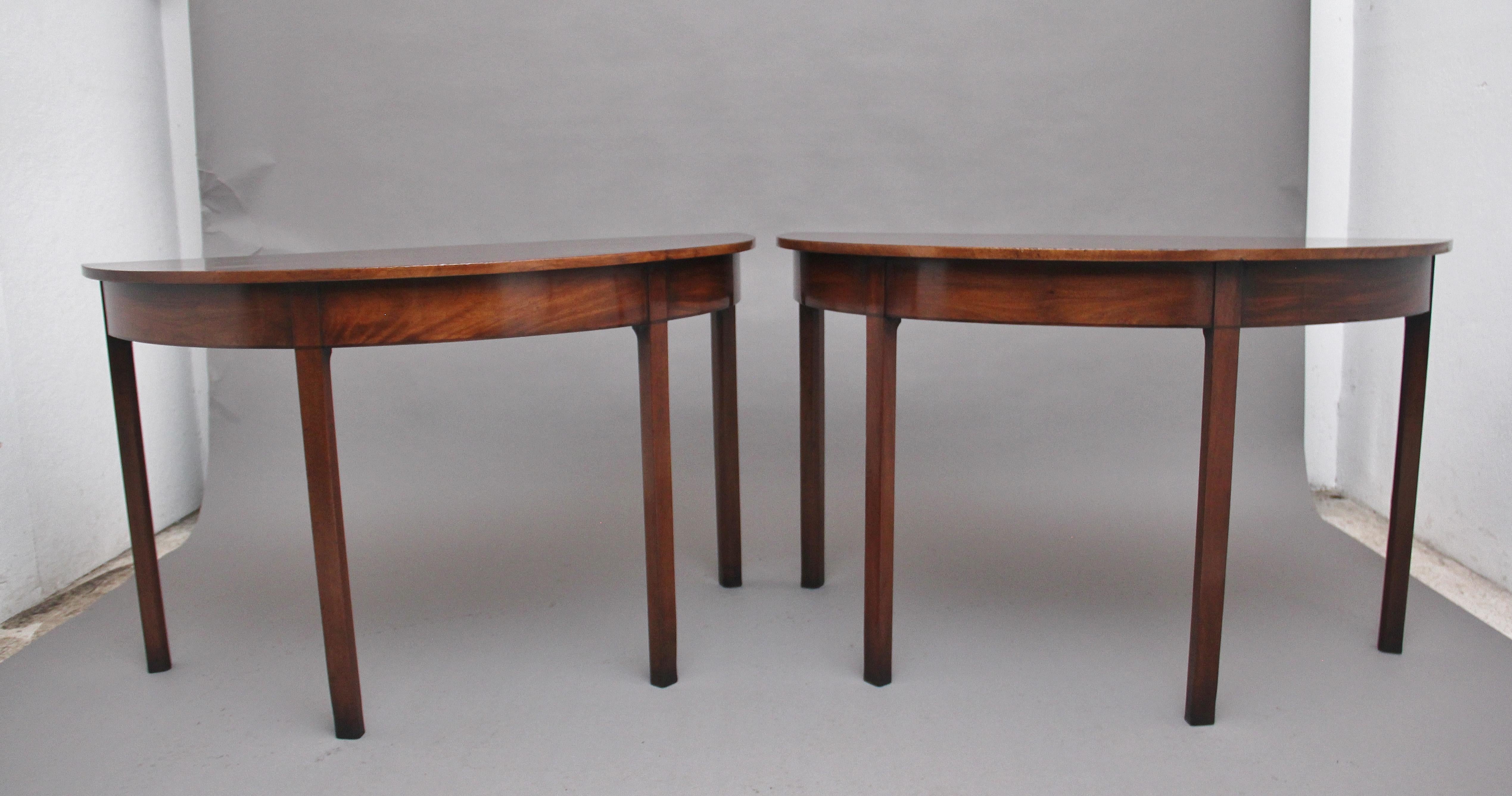 A fine pair of early 19th century mahogany demi-lune console tables, having lovely figured tops above a deep frieze supported on square tapering legs, lovely colour and in excellent condition. Circa 1800.
  