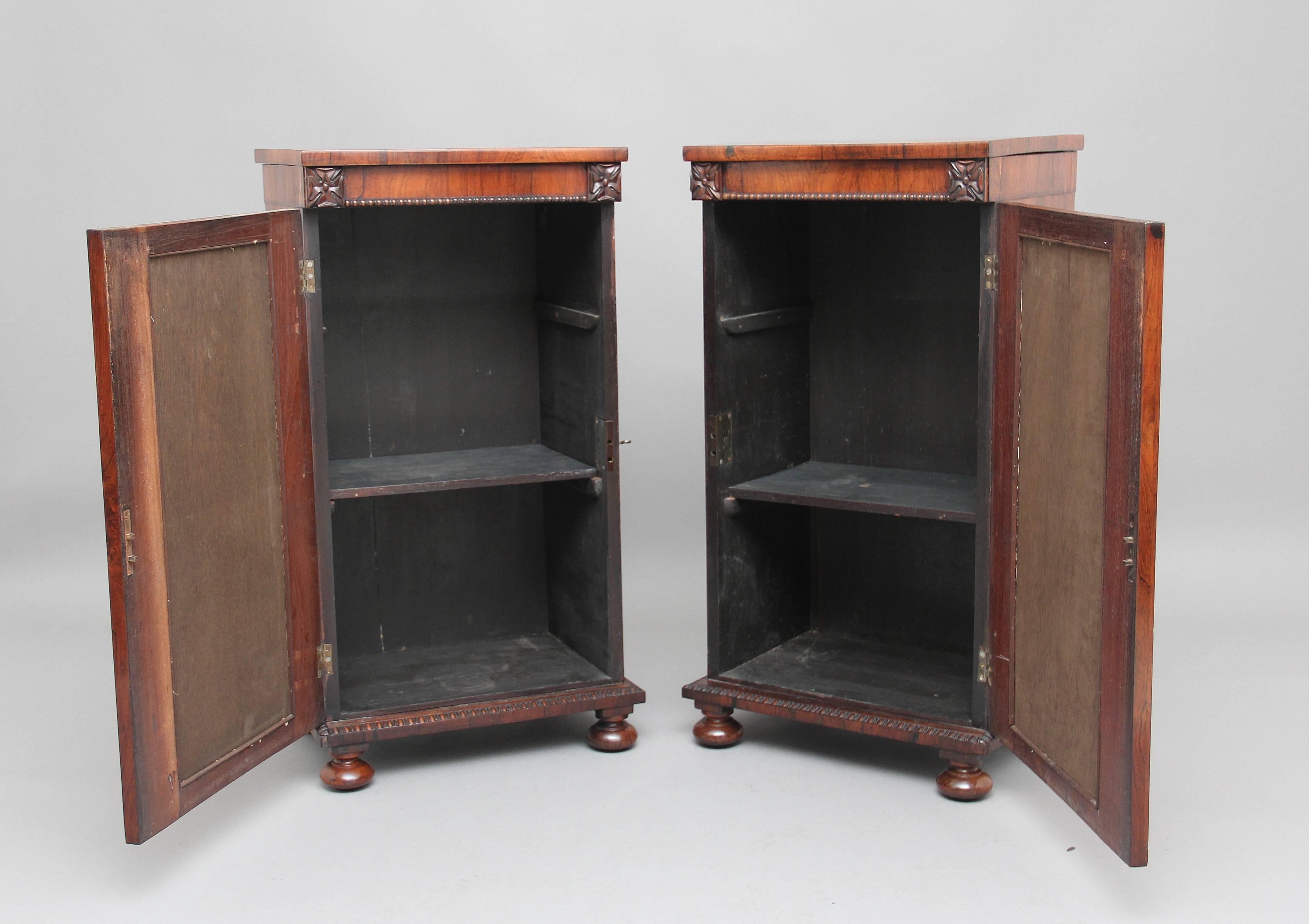 A lovely pair of 19th century rosewood pedestal cabinets, nice figured rosewood tops, the front of the cabinets having carved patraes either side at the top, columns either side with beading running along in each column, the hinged door having a