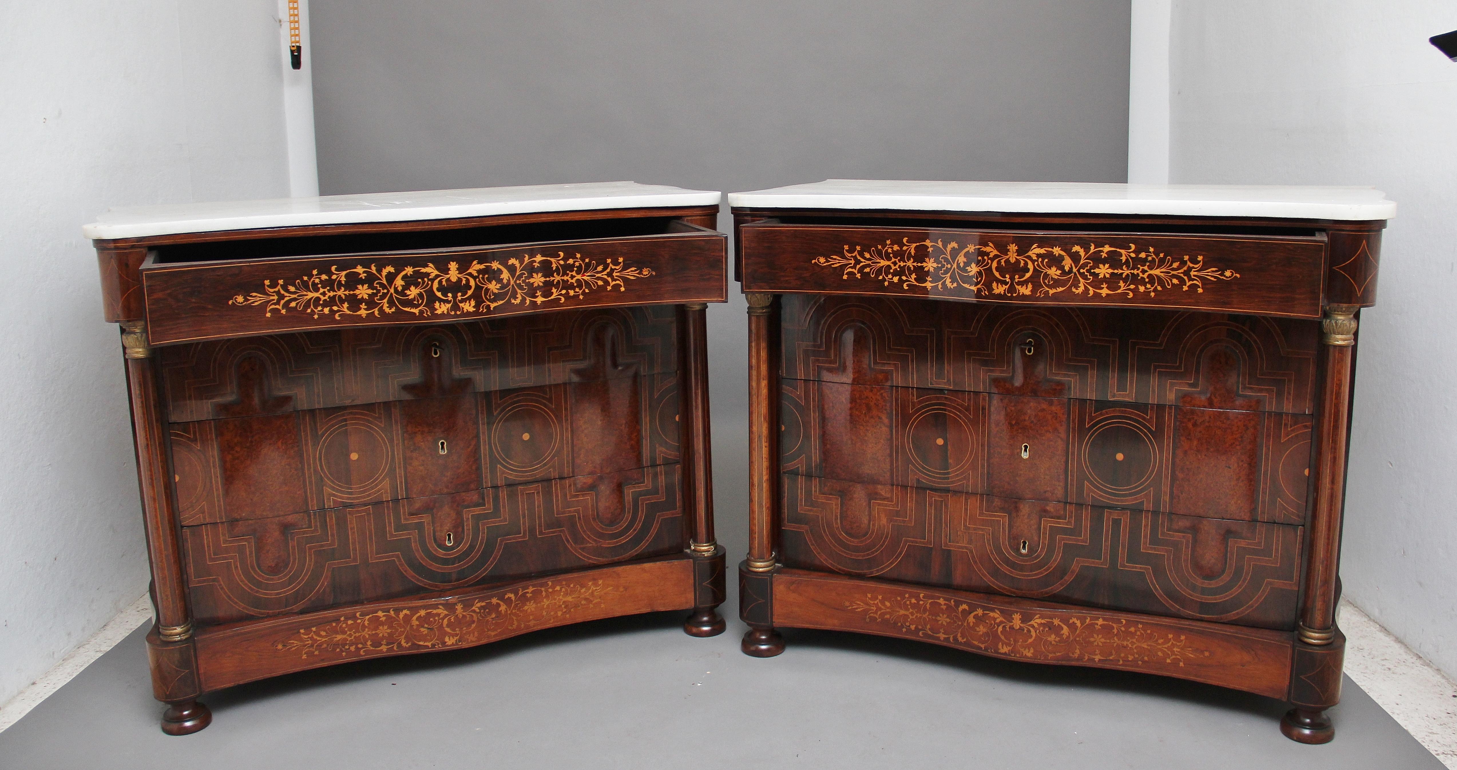 A fabulous pair of Spanish (mallorcan) early 19th century marble top commodes of serpentine form, inlaid and veneered in exotic woods such as rosewood, walnut, yew wood and boxwood, having the original white marble tops above a frieze drawer with