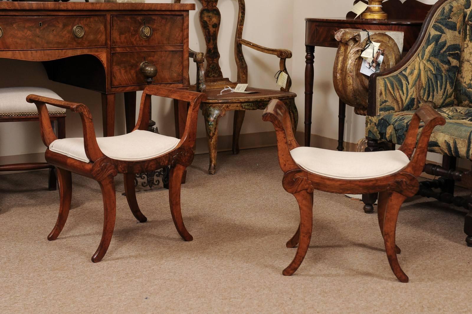 The pair of early 19th century Swiss walnut benches with scrolled arms, down swept upholstered seats and spayed legs. 

 