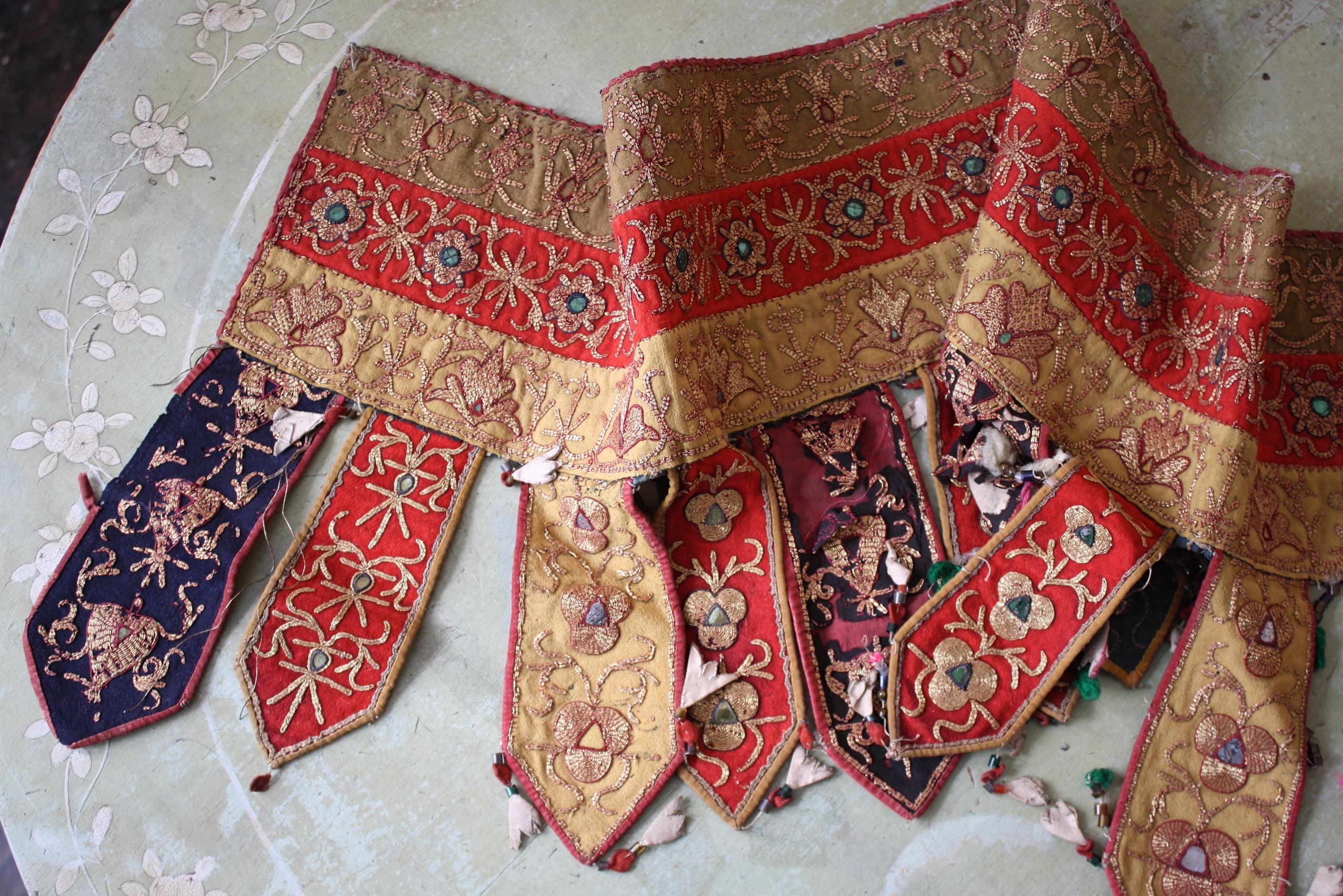 Two bejewelled and gold threaded Afghan embroidered textile door pelmets.

In very much country house untouched condition, with areas of wear and discolouration 

The lager of the two measures 127cm in length with a drop of 22
The smaller 88cm