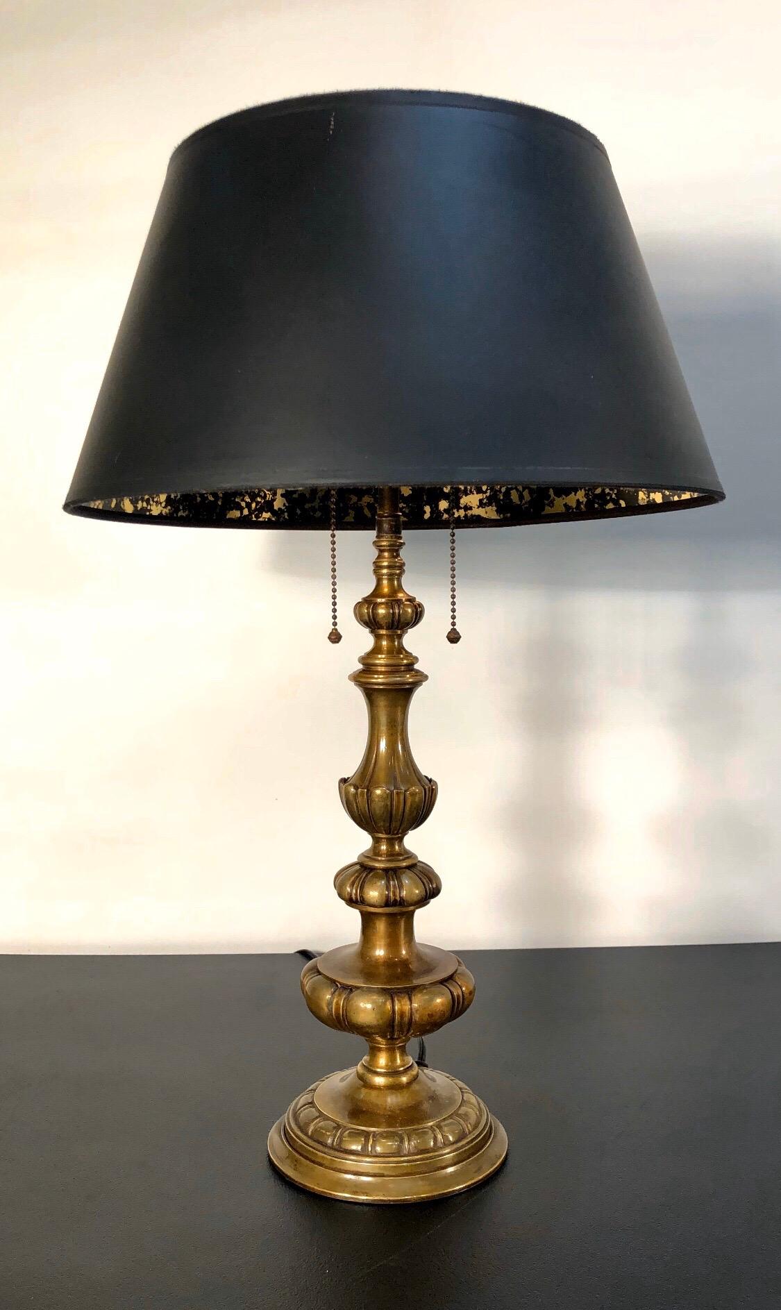 Elegant pair of Caldwell lamp in the Baroque style with Baluster stem that is finished in a beautiful hand rubbed bronze. These lamps come with the original two light cluster and acorn pull chains.