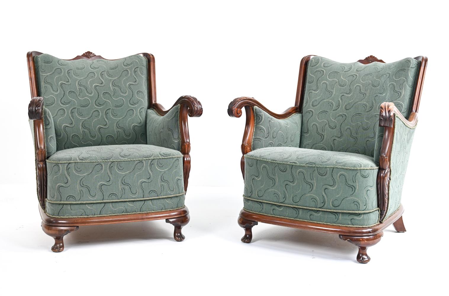 Unusual pair of Scandinavian bergere-form club chairs with solid carved wood frames, overstuffed sprung seats, and period sculpted bouclette upholstery. Early 20th century, possibly 1920's.