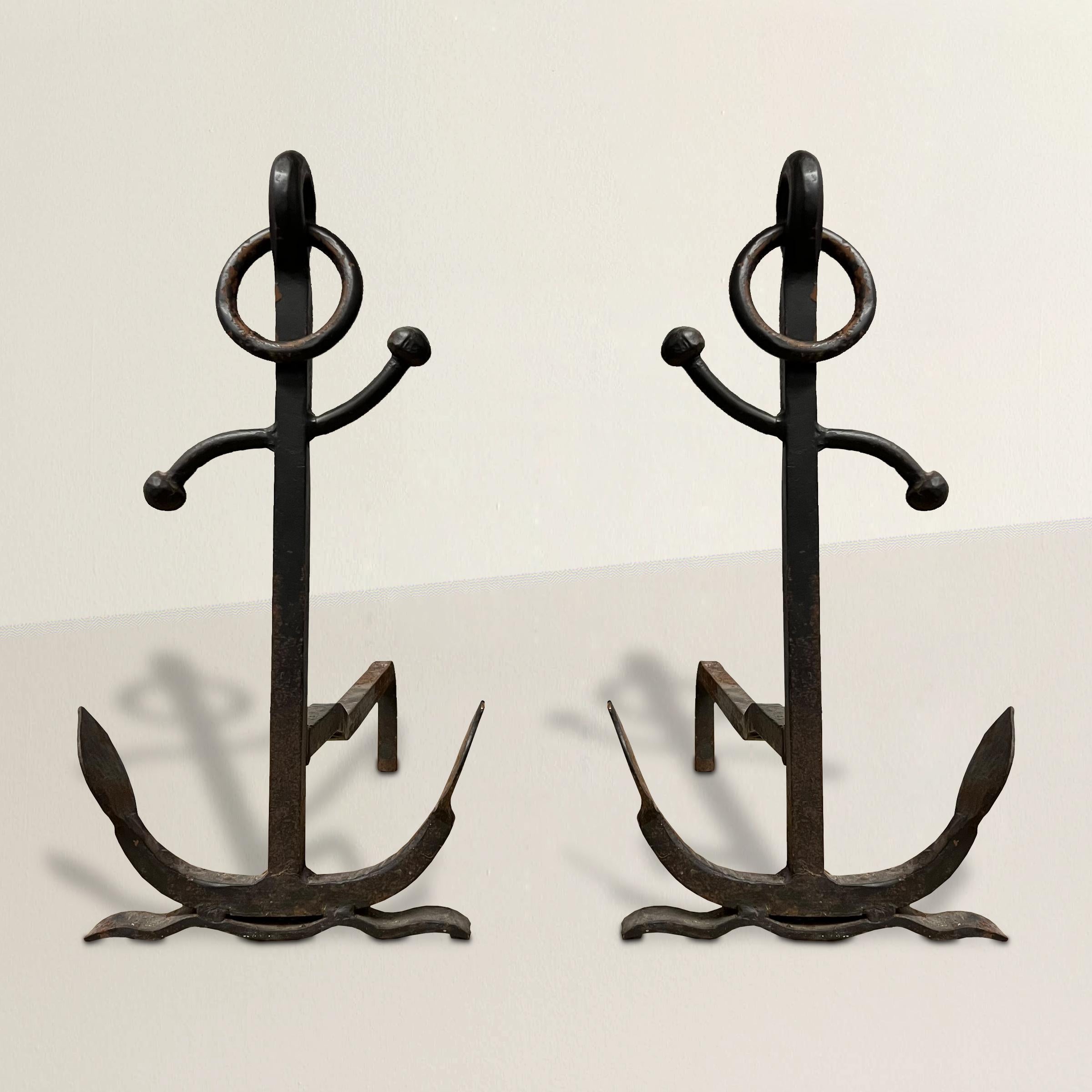 Embrace the adventurous spirit of the sea with this remarkable pair of early 20th-century American iron anchor andirons, a captivating homage to maritime heritage. Crafted with meticulous detail, these andirons pay tribute to the timeless art of