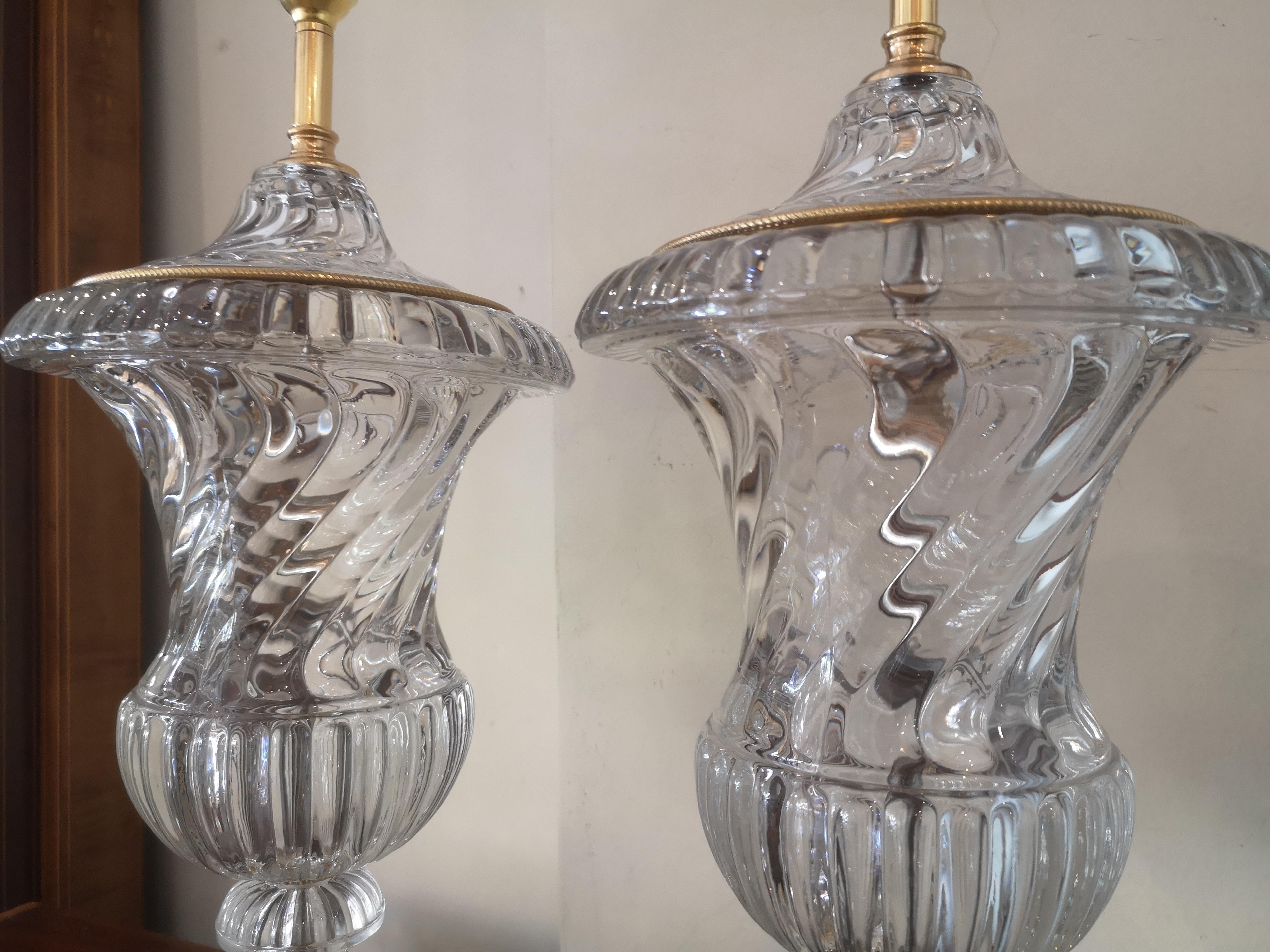 A pair of early 20th century French Baccarat style lamps, with swirling urn shaped crystal bodies and bronze banding.
Recently re-wired.
French, circa 1920.
