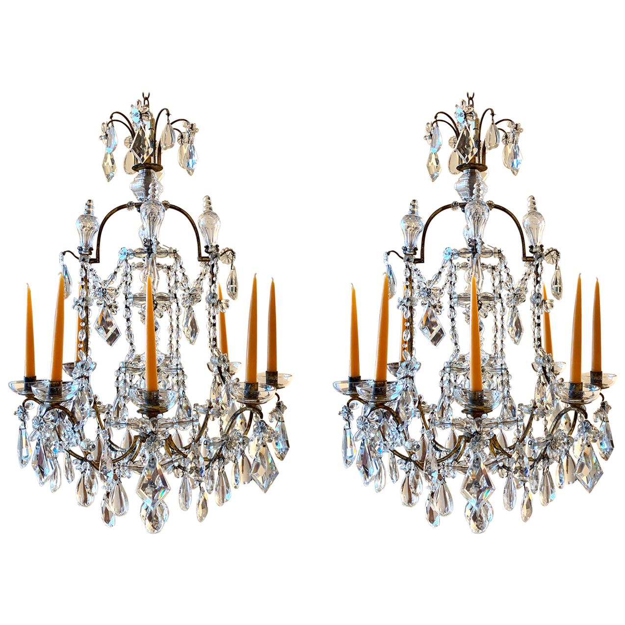 Pair of finely manufactured Maison Baguès hammered iron and handcut French crystal chandeliers. Crystals all original as are the crystal 