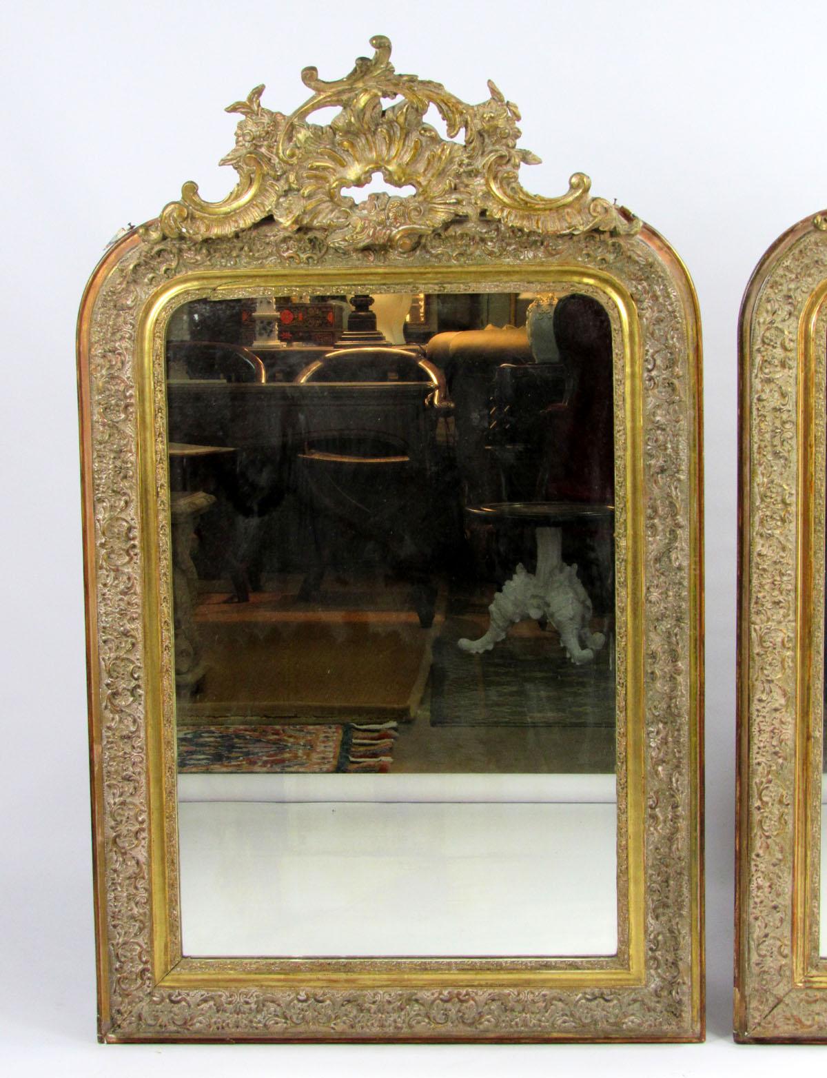 Pair of Belle Époque style carved giltwood mirrors, rectangular plate within gilt frame surmounted by scrolling crest.
