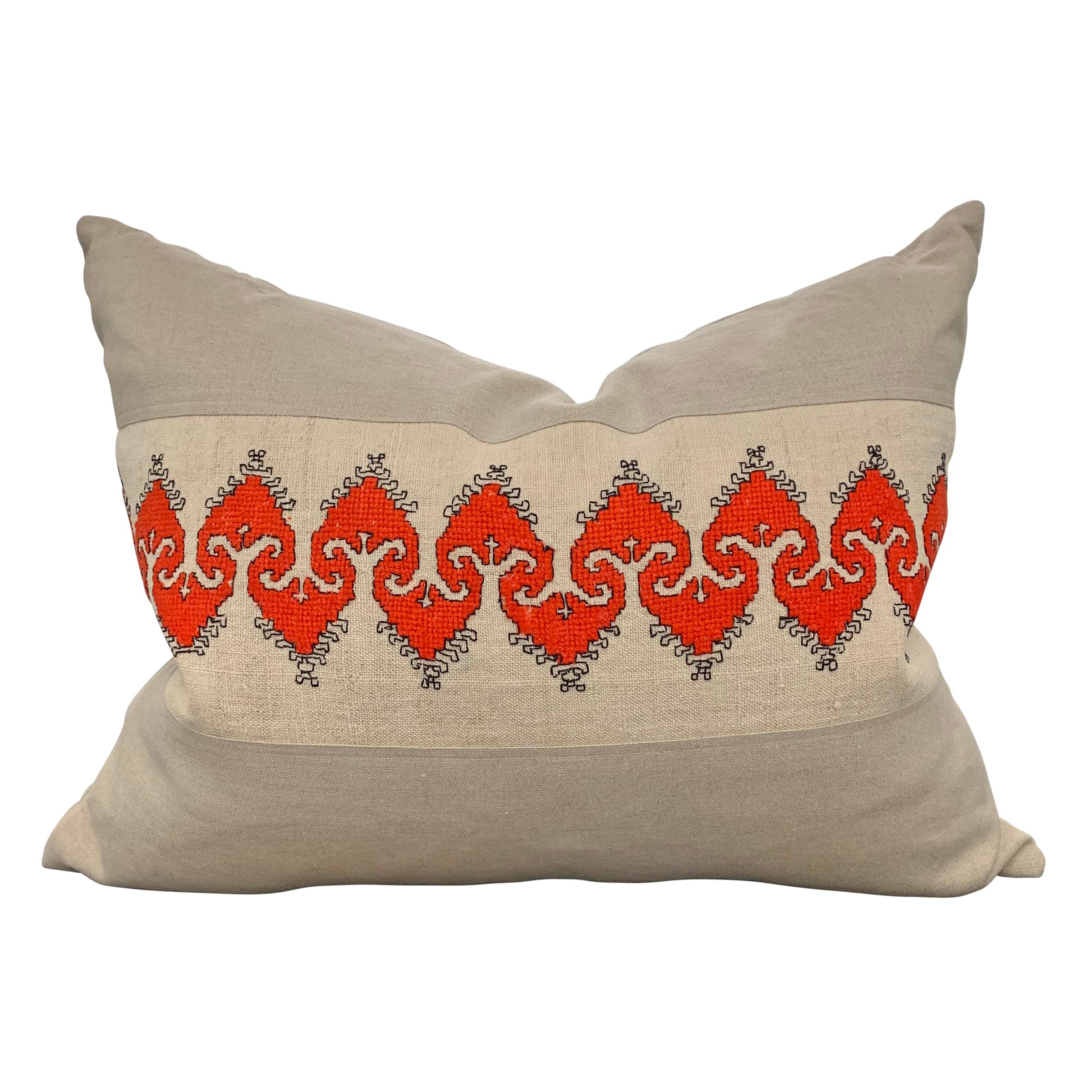 A wonderful pair of pillows made from panels of early 20th century Bulgarian folk embroidery using a brilliant coral colored thread, mounted and back with handwoven linen. Filled with down.