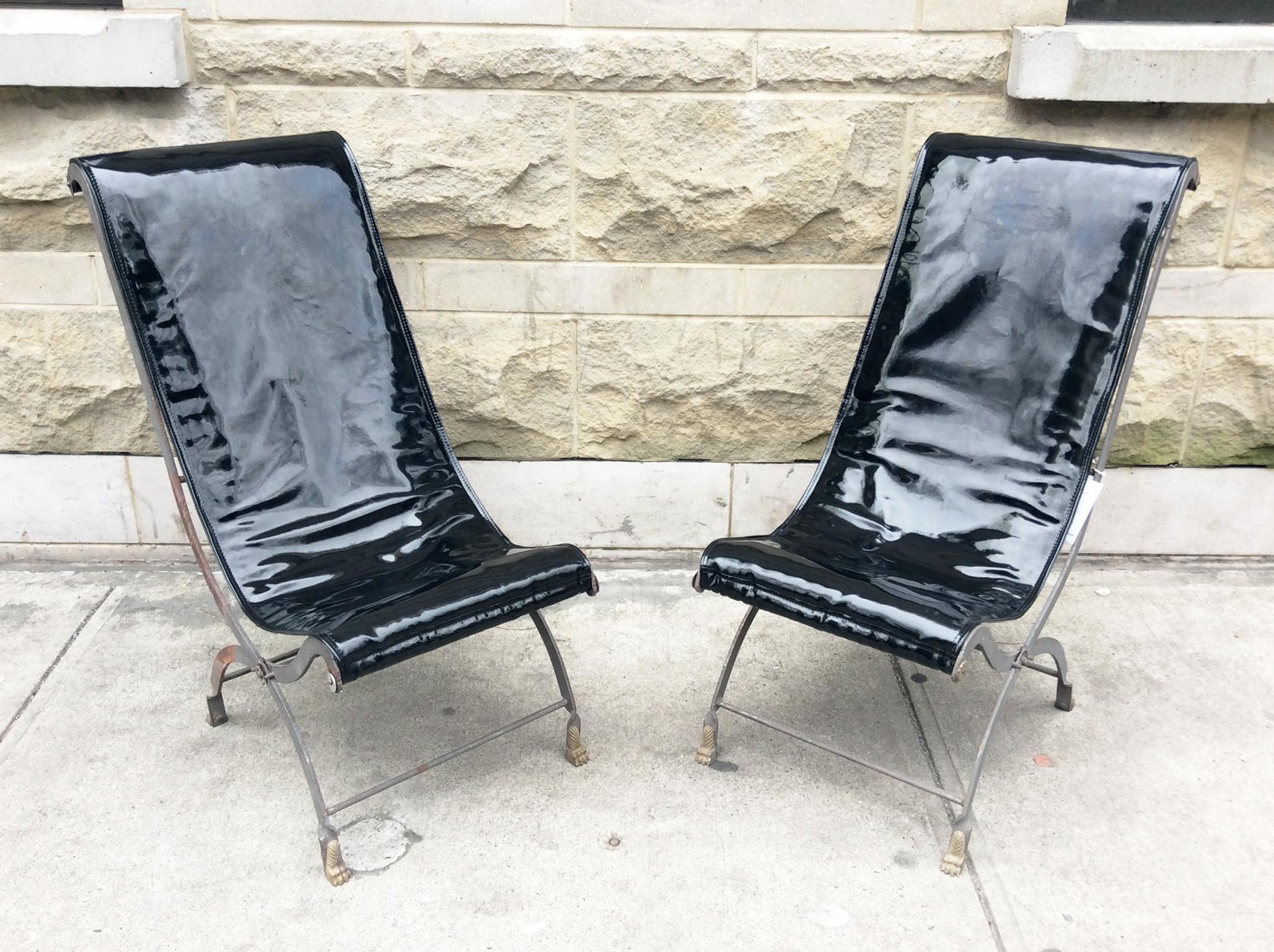 A very alluring and unique pair of armless folding lounge chairs designed in the manner of Maison Jansen. The chairs' frames were crafted in the early 20th century. They are re-imagined in a modern form with new black patent leather upholstery. The