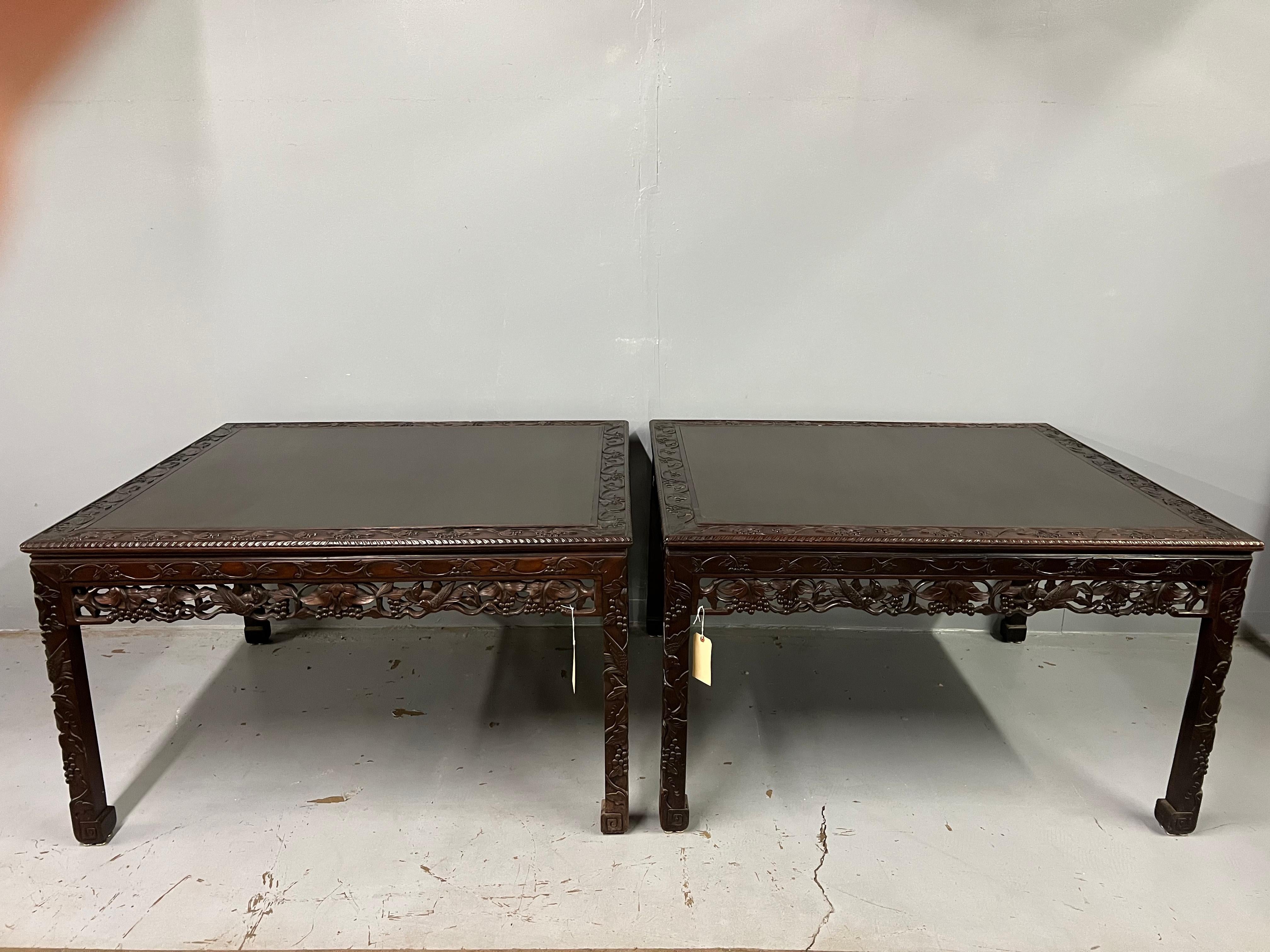 A pair of Chinese carved rosewood center tables that could be used for dining as well. They are part of a suite of dining furniture made Europeans living in China in the early 20th century. These beautifully carved tables are a wonderful size and