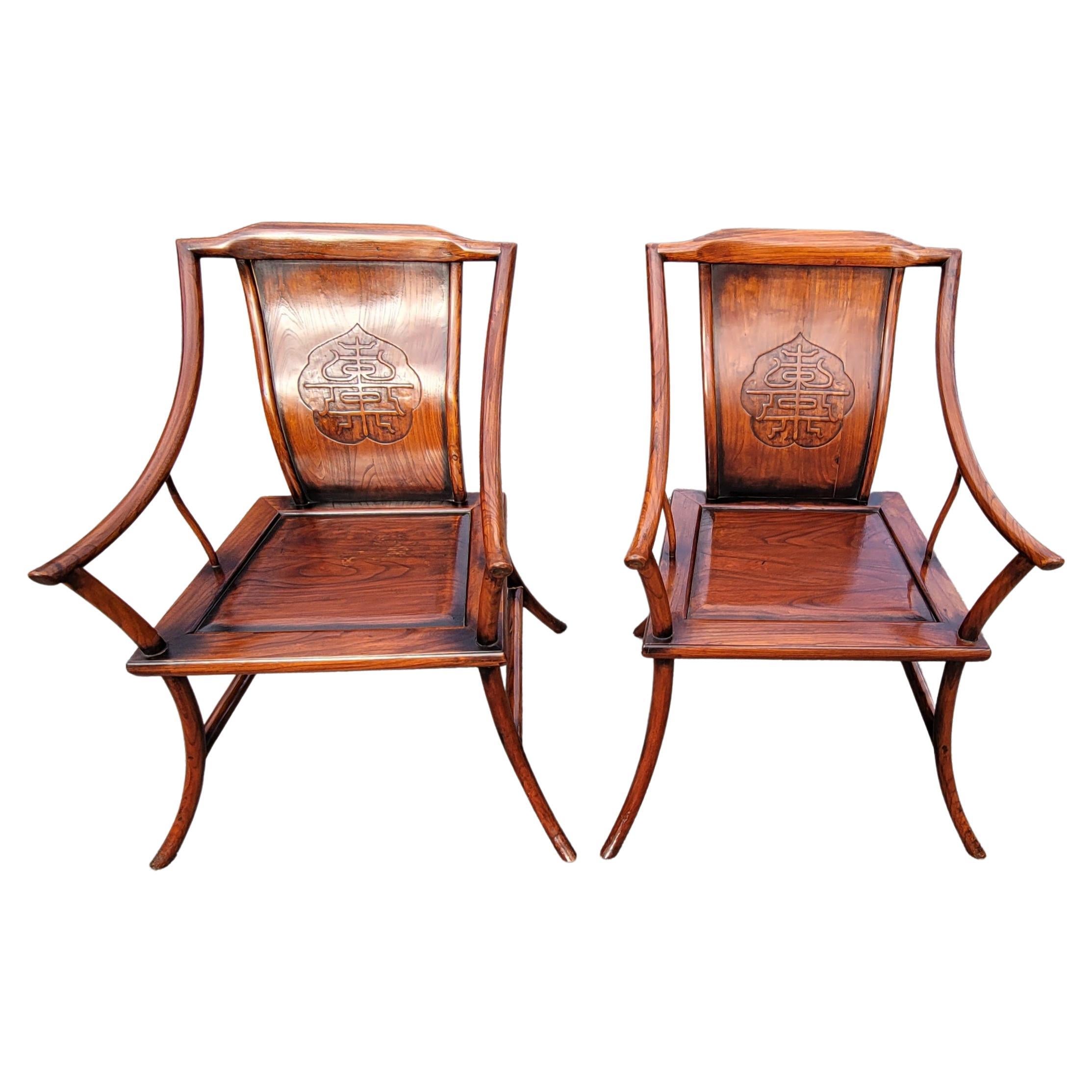 A Pair of Early 20th century Chinese elmwood armchairs with finely carved back and elongated arms and legs. 
Measure 30