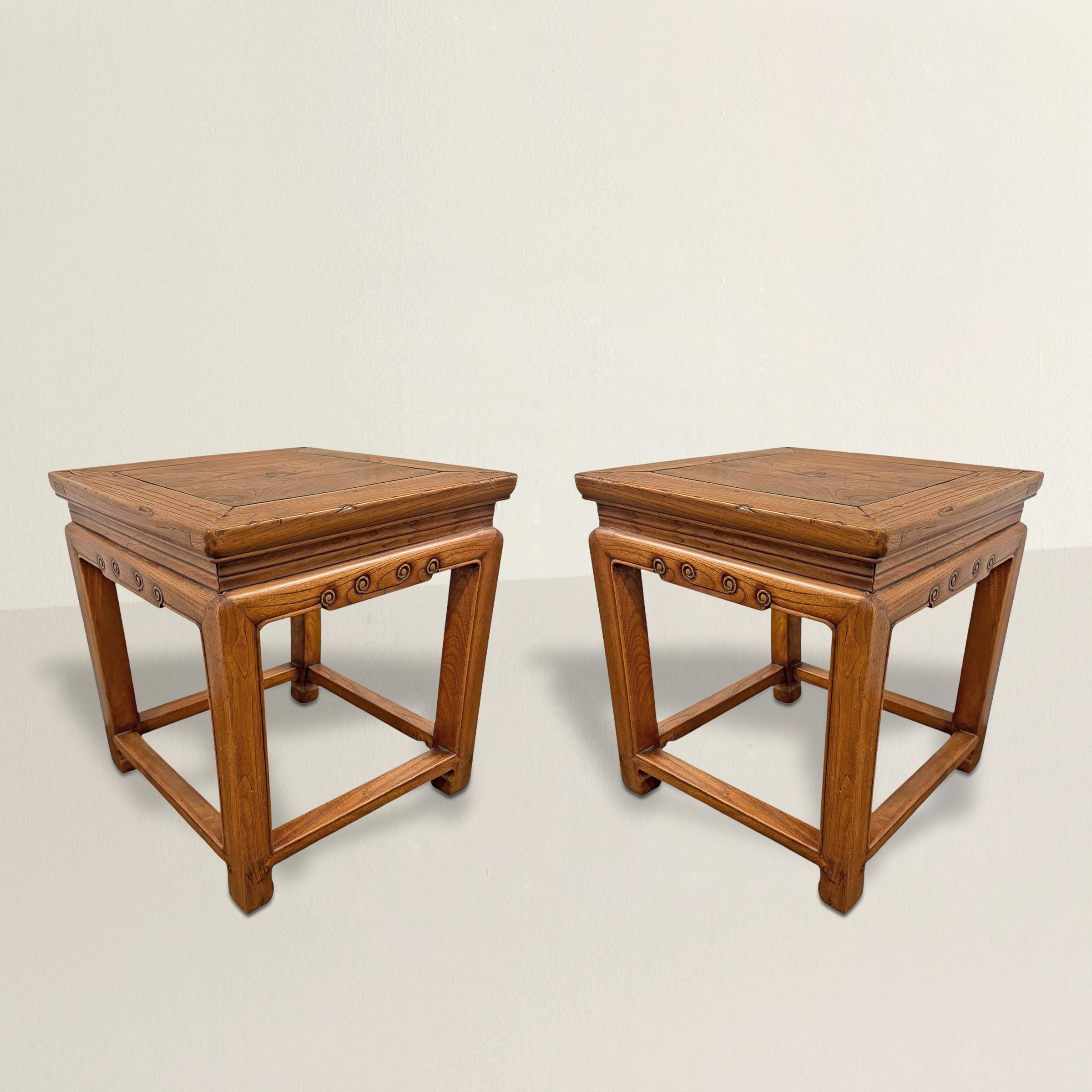 Rooted in the elegance of Ming design, this pair of early 20th-century Chinese elmwood stools is all about balance—nothing extra, nothing missing. Straight square legs end in stylized hoof feet, giving them a quiet strength, while the high waists