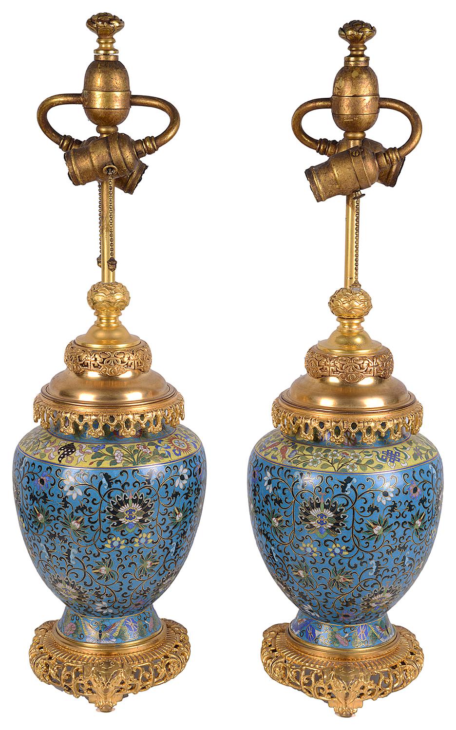 A very good quality pair of late 19th century Chinese cloisonné enamel and gilded ormolu vases / lamps. Each with wonderful classical bold colours, scrolling motif and foliate decoration.