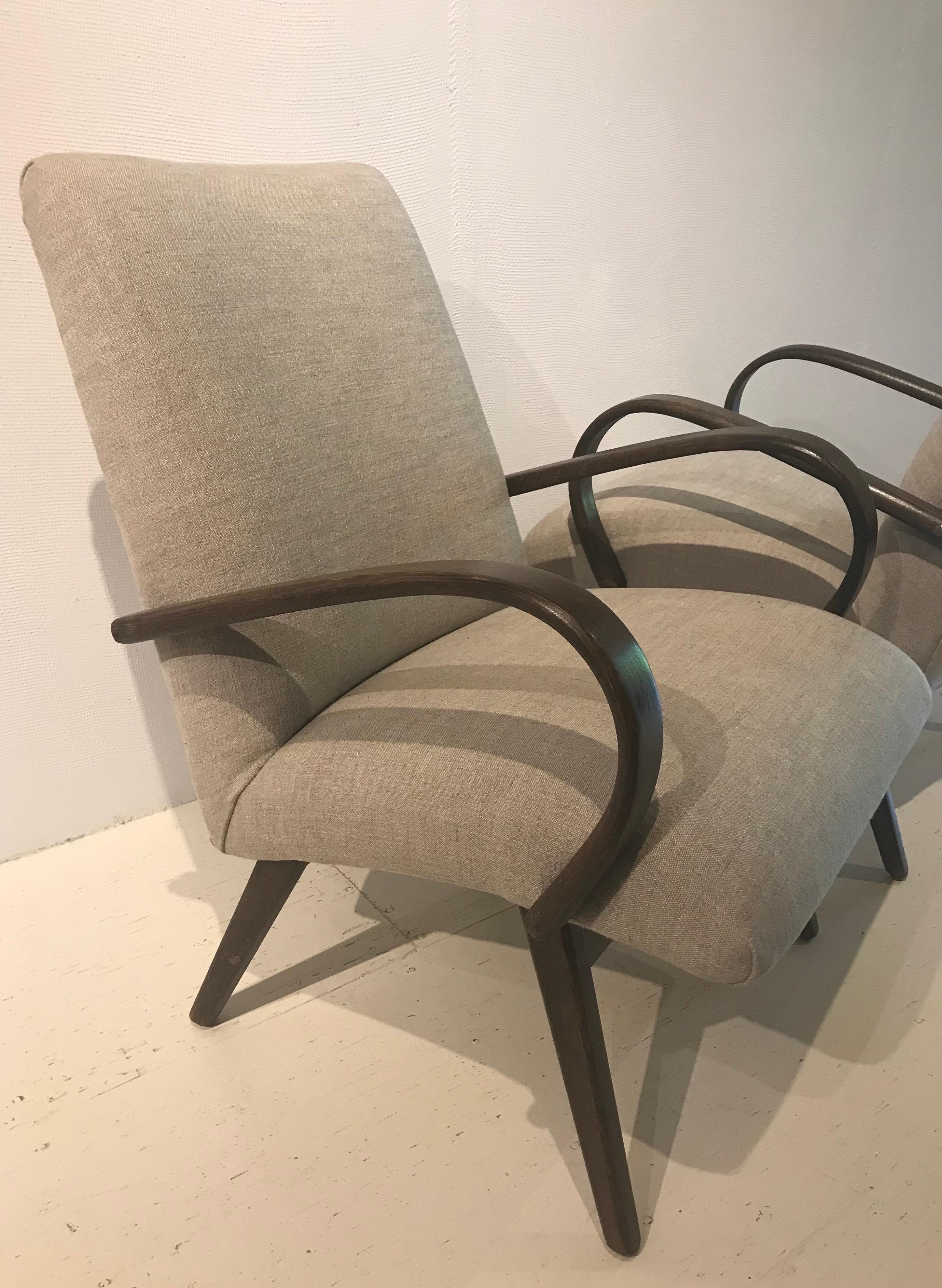 The pair of Danish lounge chairs have an elegant presence without stealing the show. Lovely bent wood arms and sleek body make the pair a grand presentation easily mixed with other periods and in any setting.