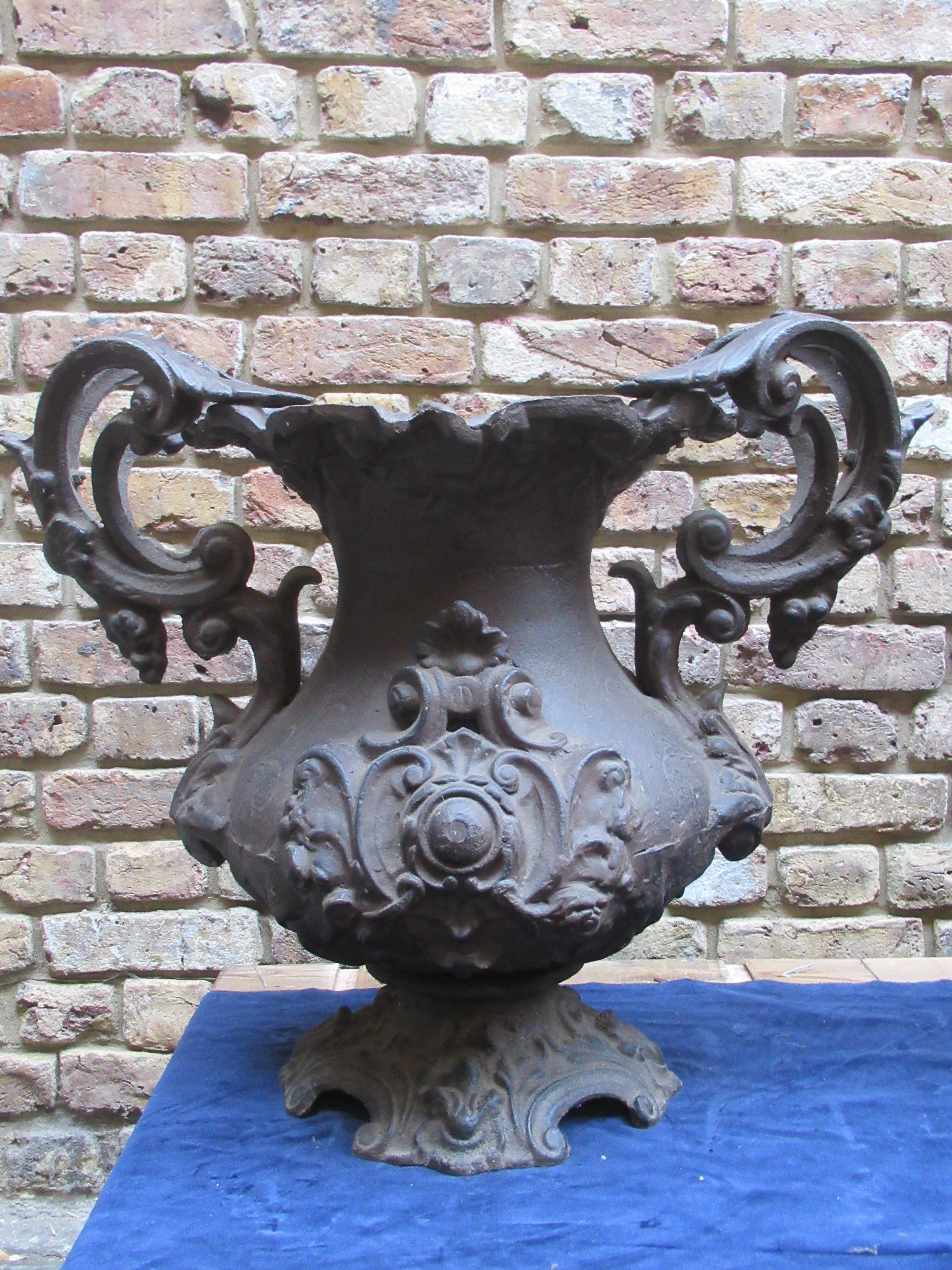 Pair of early 20th century cast iron urns with decorative foliate work and scroll handles.
Beautiful shape and detail with a good patina for the age.
Perfect for statement for your garden or entrance.