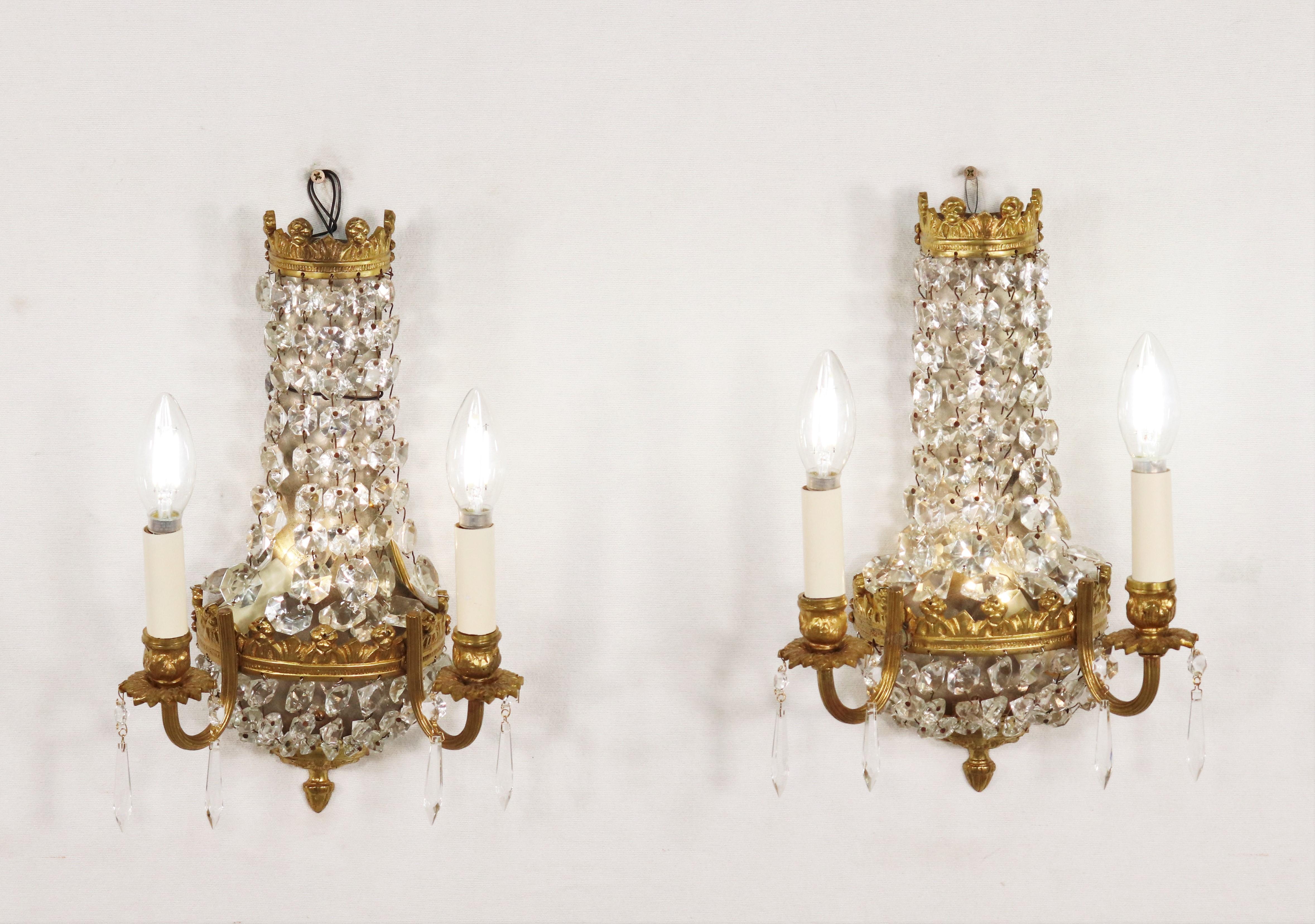 These early 20th-century Empire-style gilt bronze and crystal sconces are a testament to elegance and sophistication. Originating in France, the Empire style drew inspiration from Ancient Rome, often featuring ormolu mounts with Roman motifs.

Each