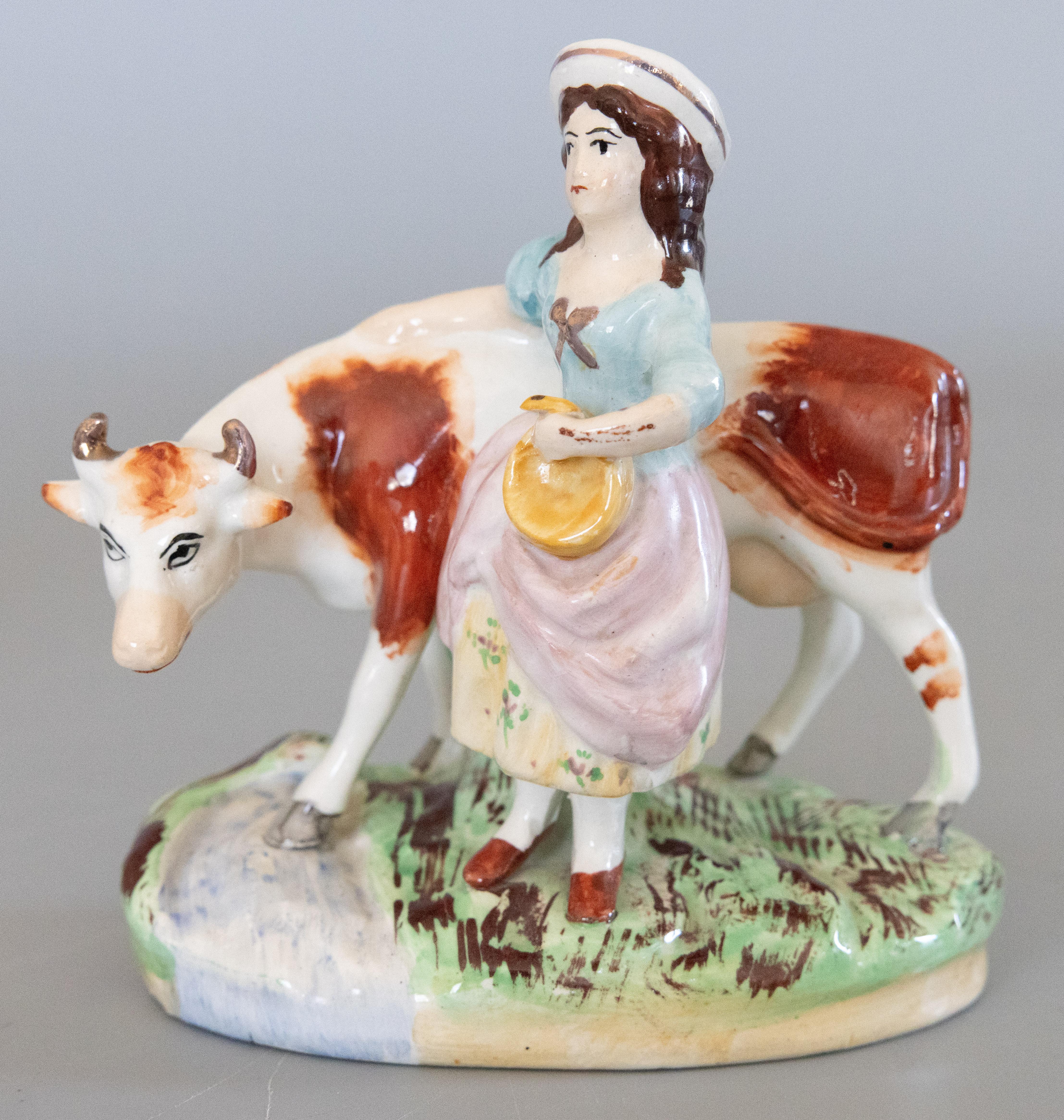 Hand-Painted Pair of Early 20th Century English Staffordshire Boy & Girl Cow Figurines For Sale