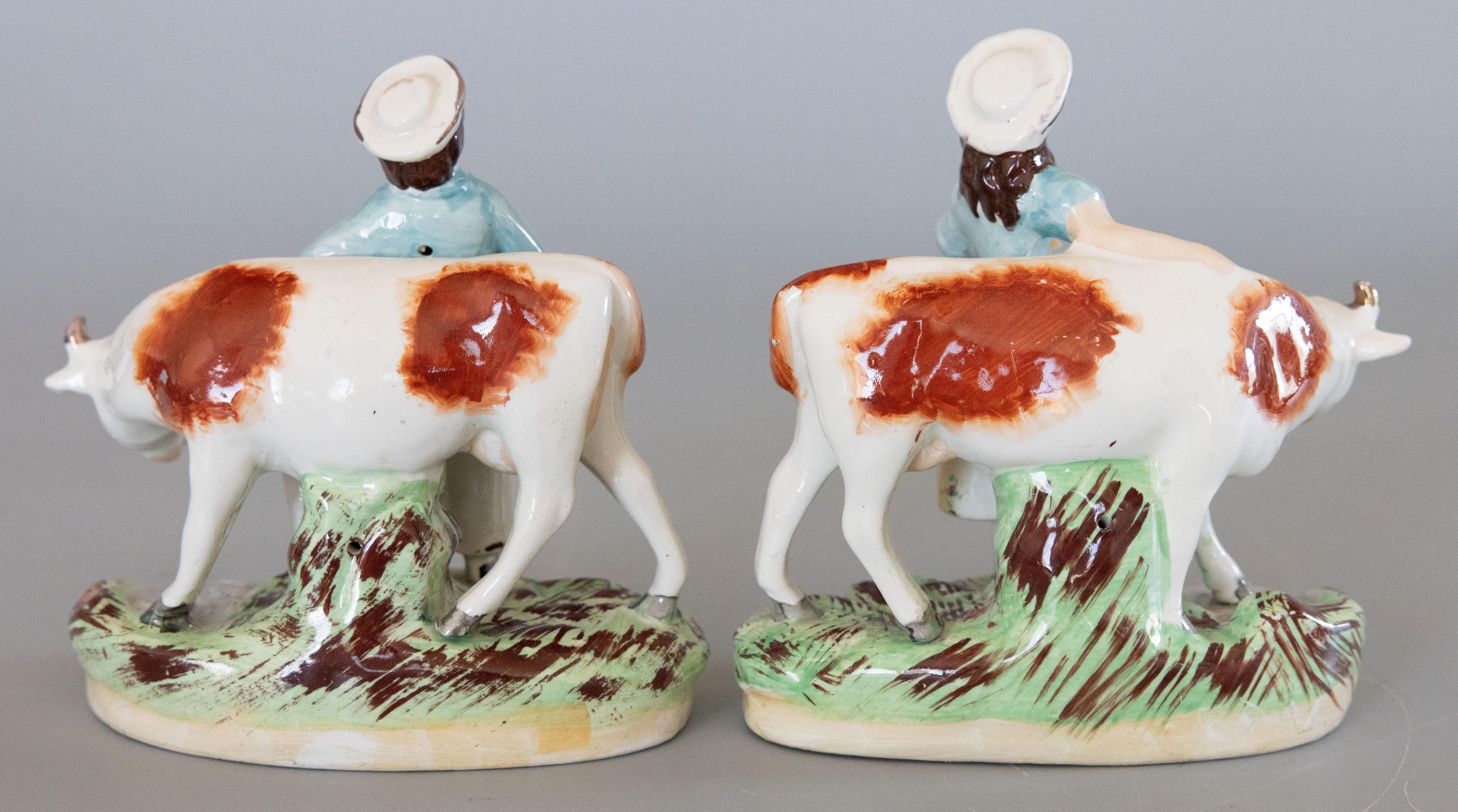 Ceramic Pair of Early 20th Century English Staffordshire Boy & Girl Cow Figurines For Sale