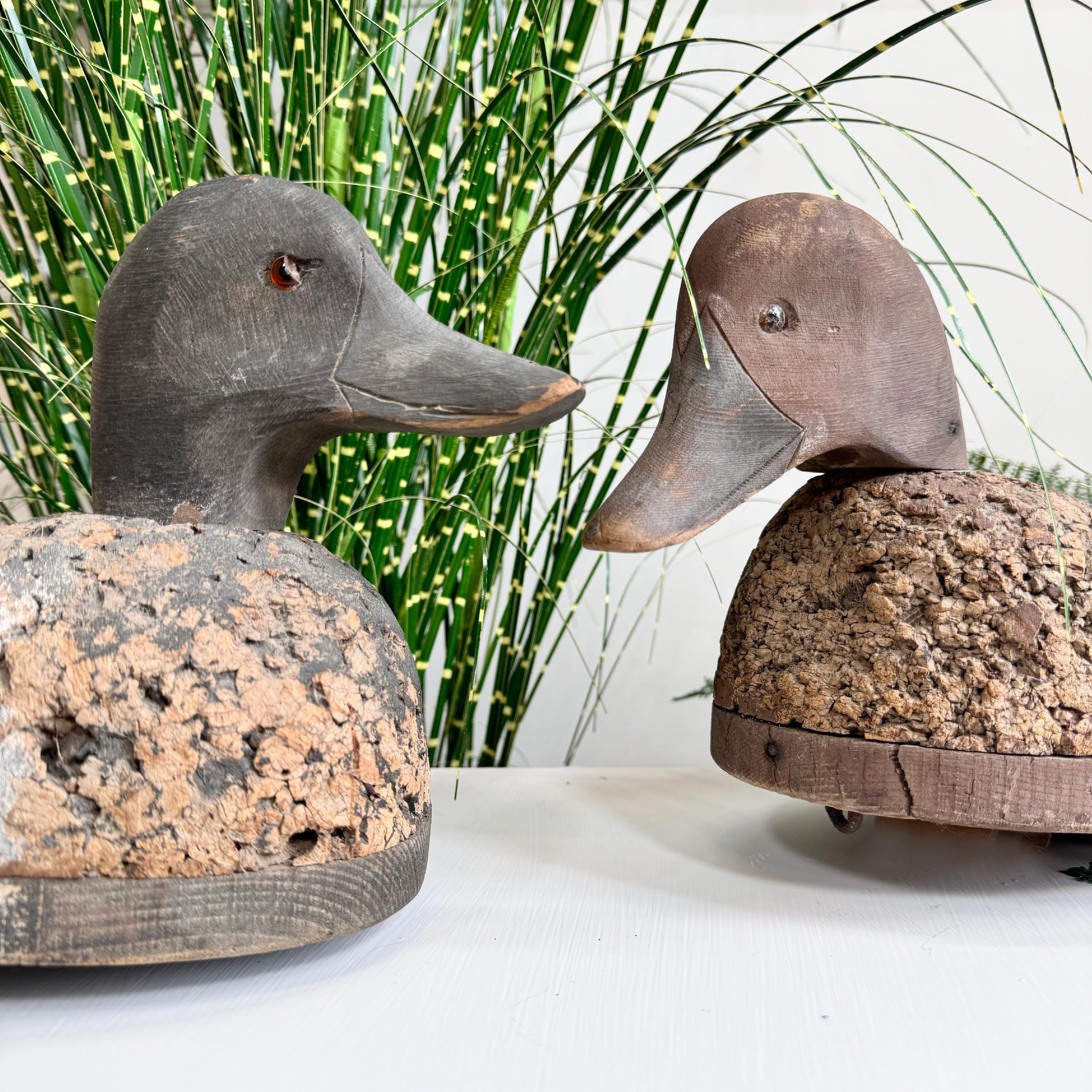 Estupenda pareja de patos señuelo de arte popular de hacia 1910-1920, hechos a mano en corcho y madera, cada uno con un antiguo soporte de hierro en la base, probablemente utilizado para arrastrarlos por el agua. Cada uno de los patos tiene pequeños