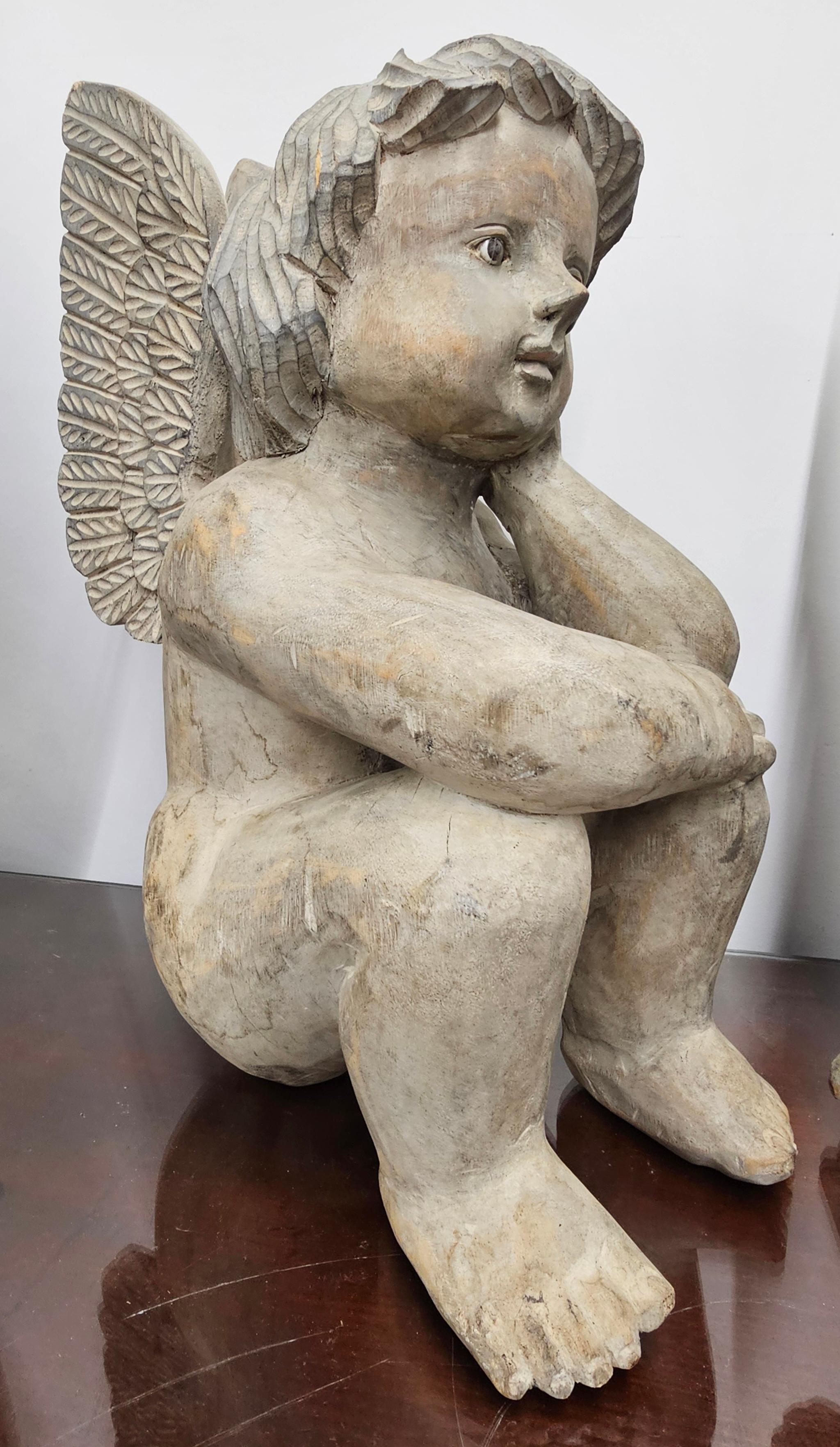 An adorable Pair of Early 20th Century Free Standing Carved Wood Cherubs, Putti  Angels. One seated and the other on his knees. Measures 15.5