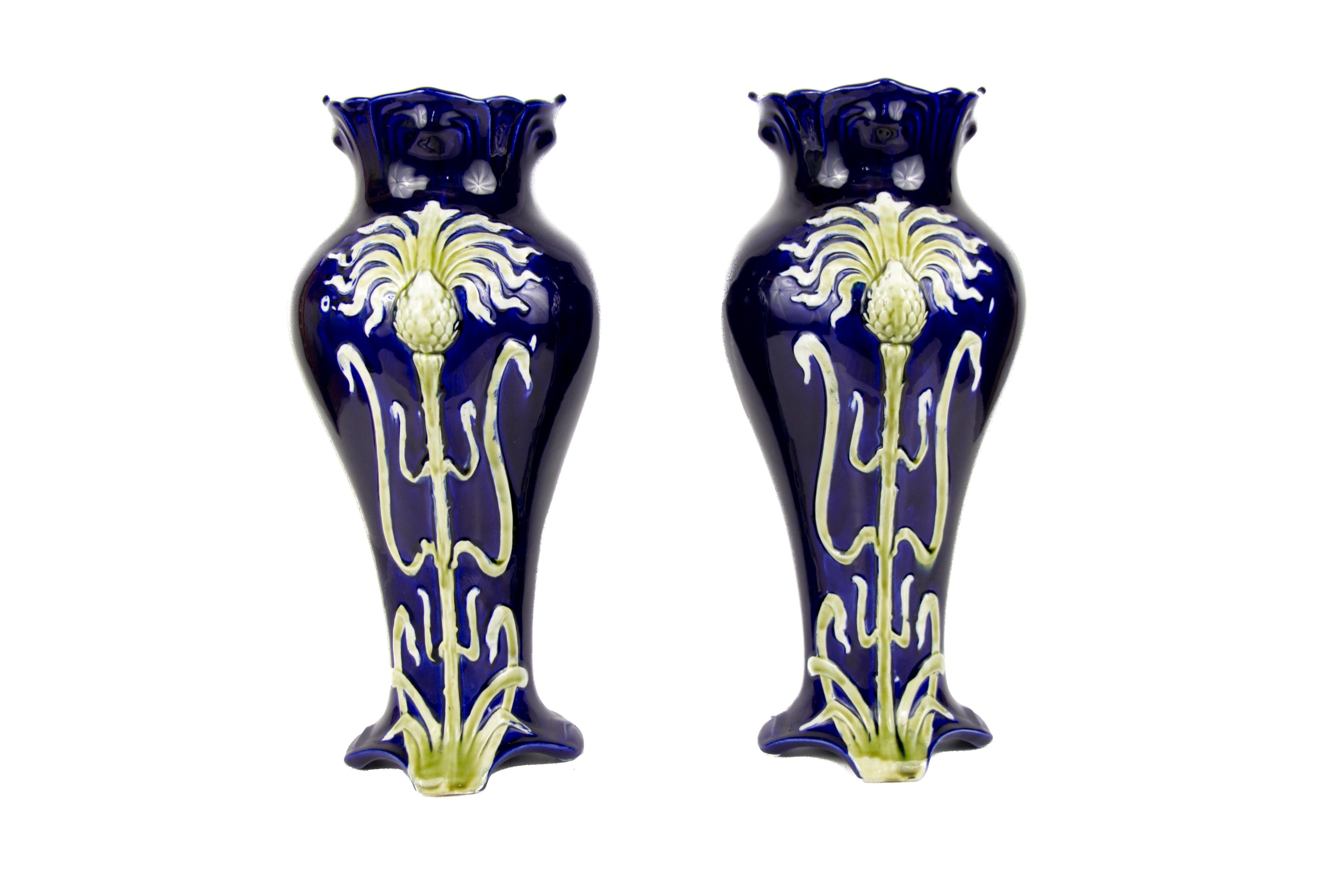 Pair of impressive French Art Nouveau majolica vases by Jean Bernard De Bruyne, circa 1900. The very decorative Art Nouveau vases are in a very good condition for the age. One of the vases has a small chip on bottom on the edge, please, see the