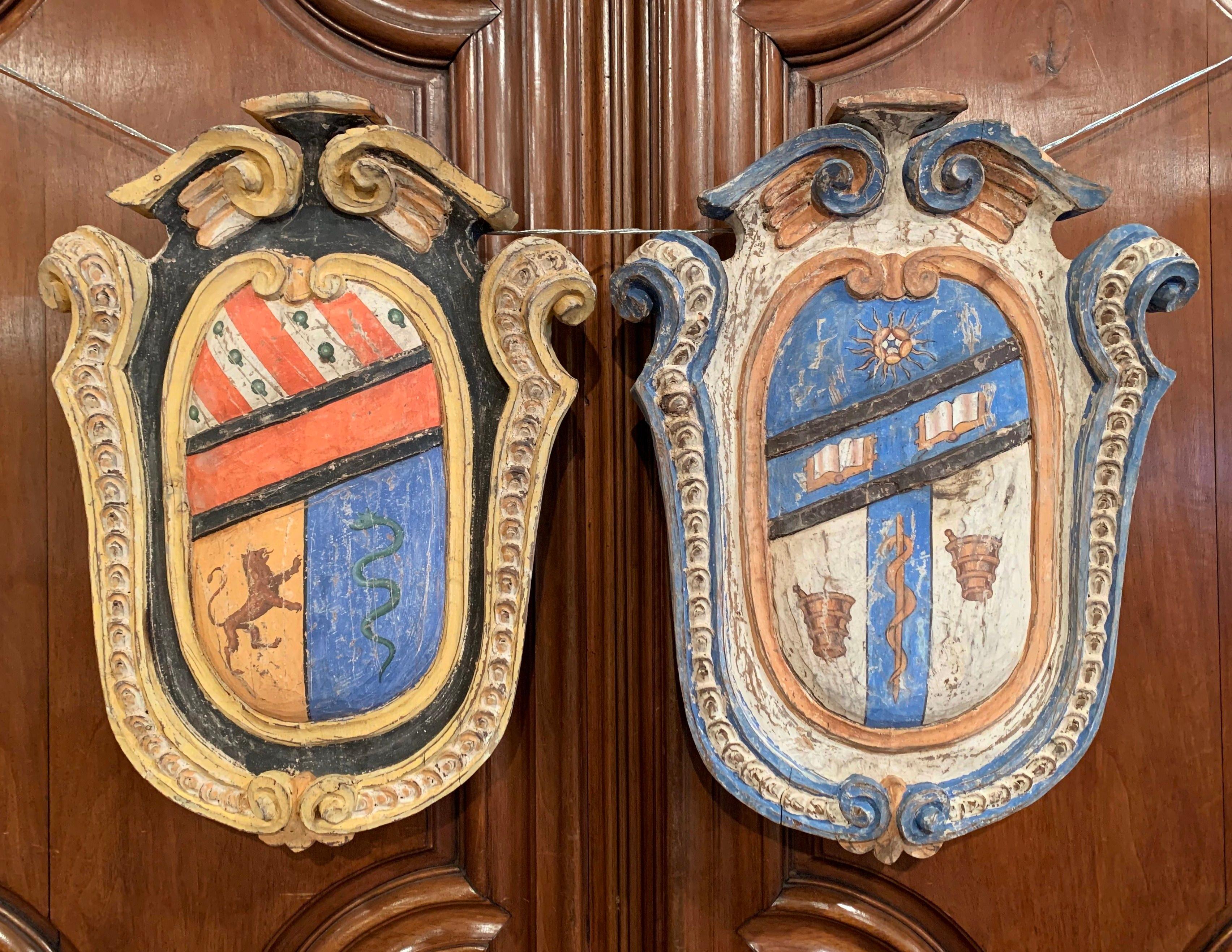 Hand-Painted Pair of Early 20th Century French Carved Painted Wall Hanging Shields with Crest